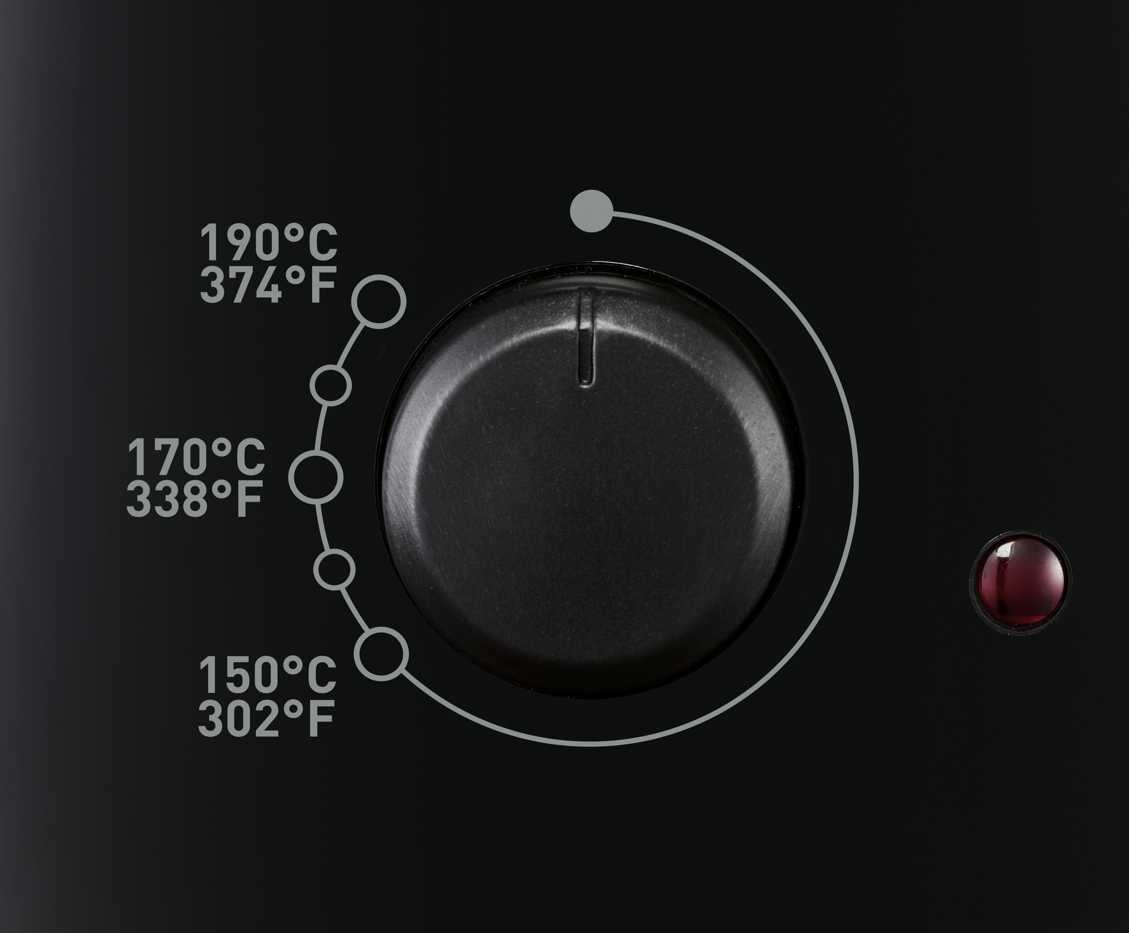 Egy fekete sütő vezérlőtárcsájának közeli képe Celsius és Fahrenheit hőmérsékleti jelzésekkel.
