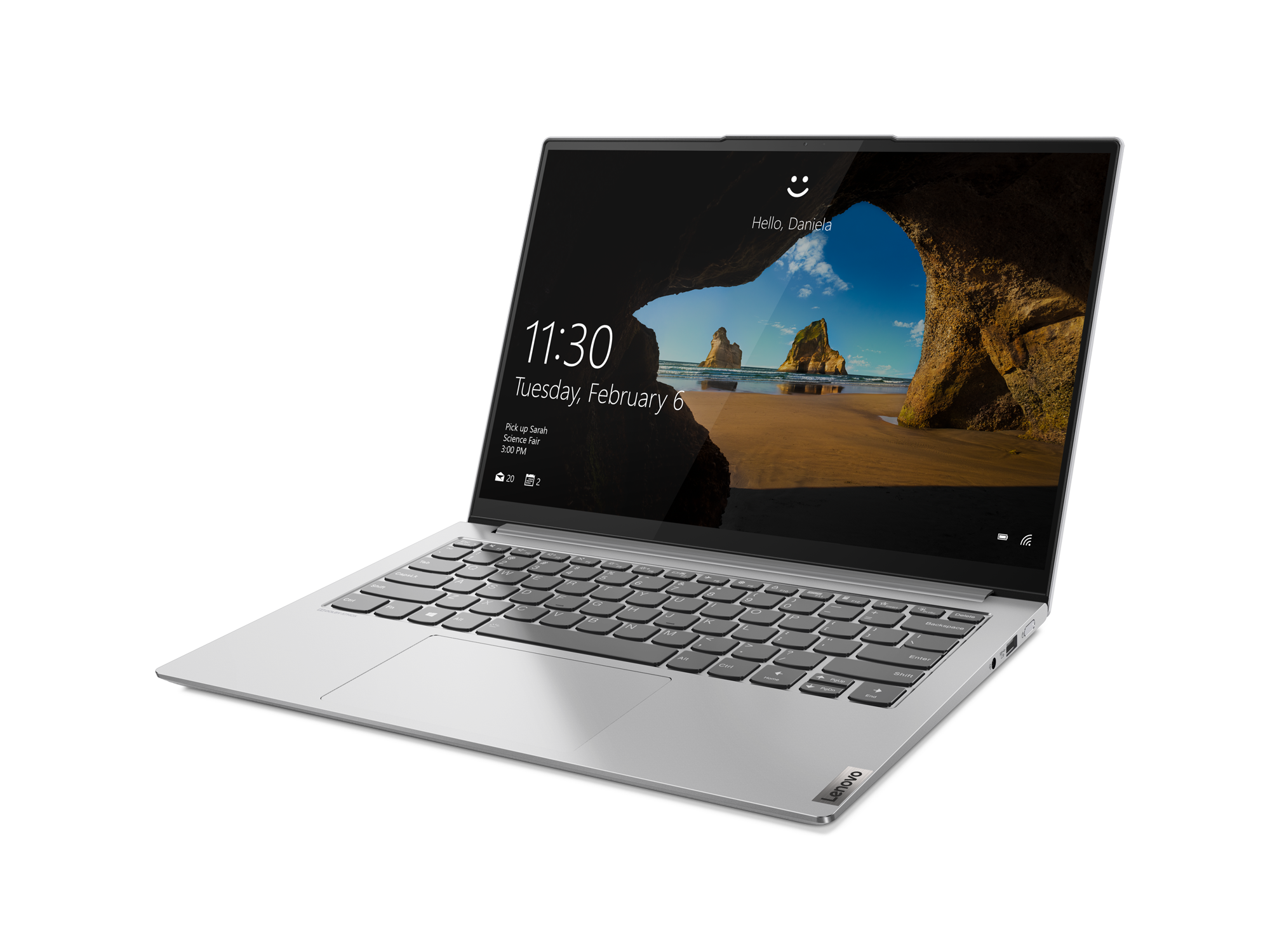 Laptop auf schwarzer Oberfläche, zeigt eine Strandszene und Benutzernamen.