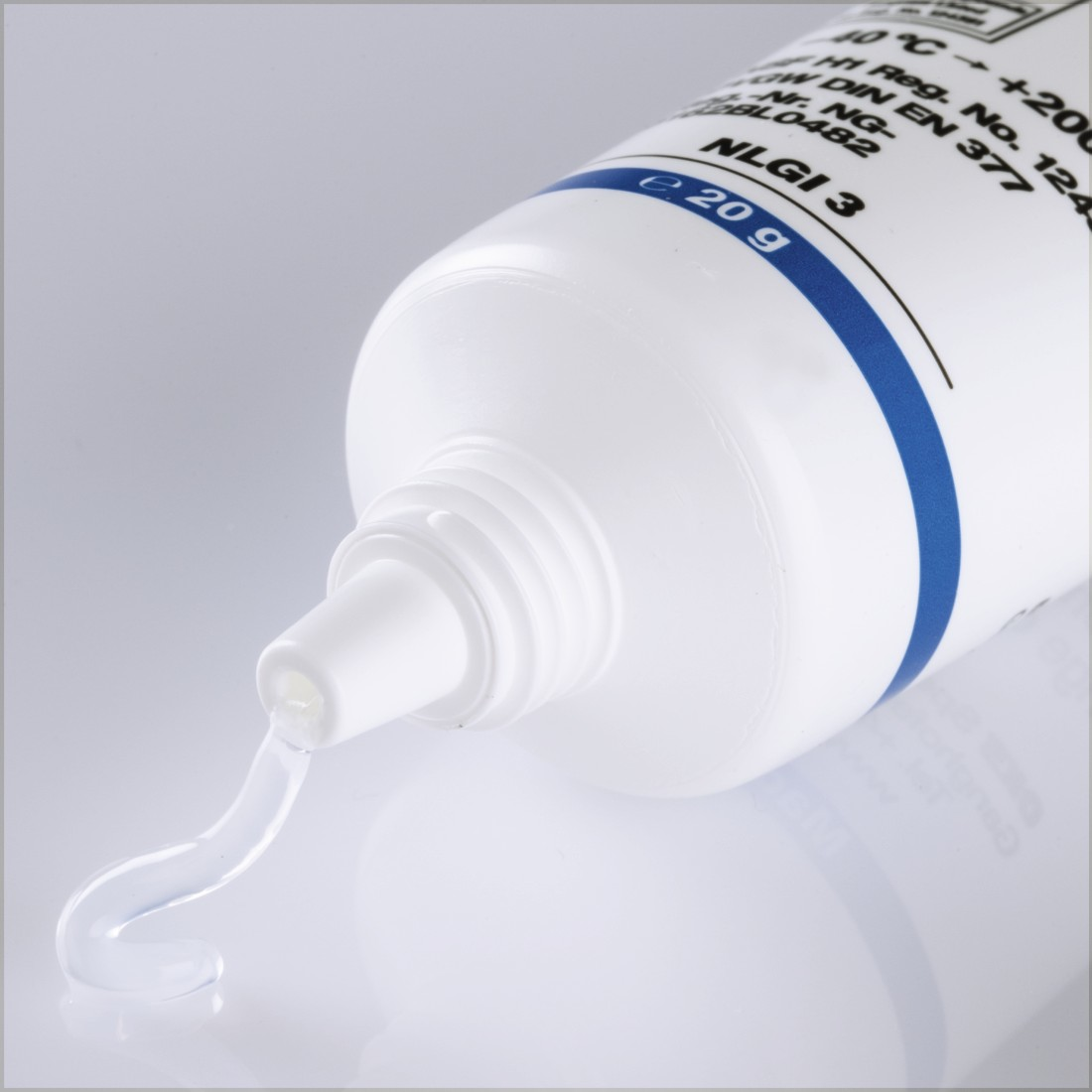 White tube of grease, product shot.