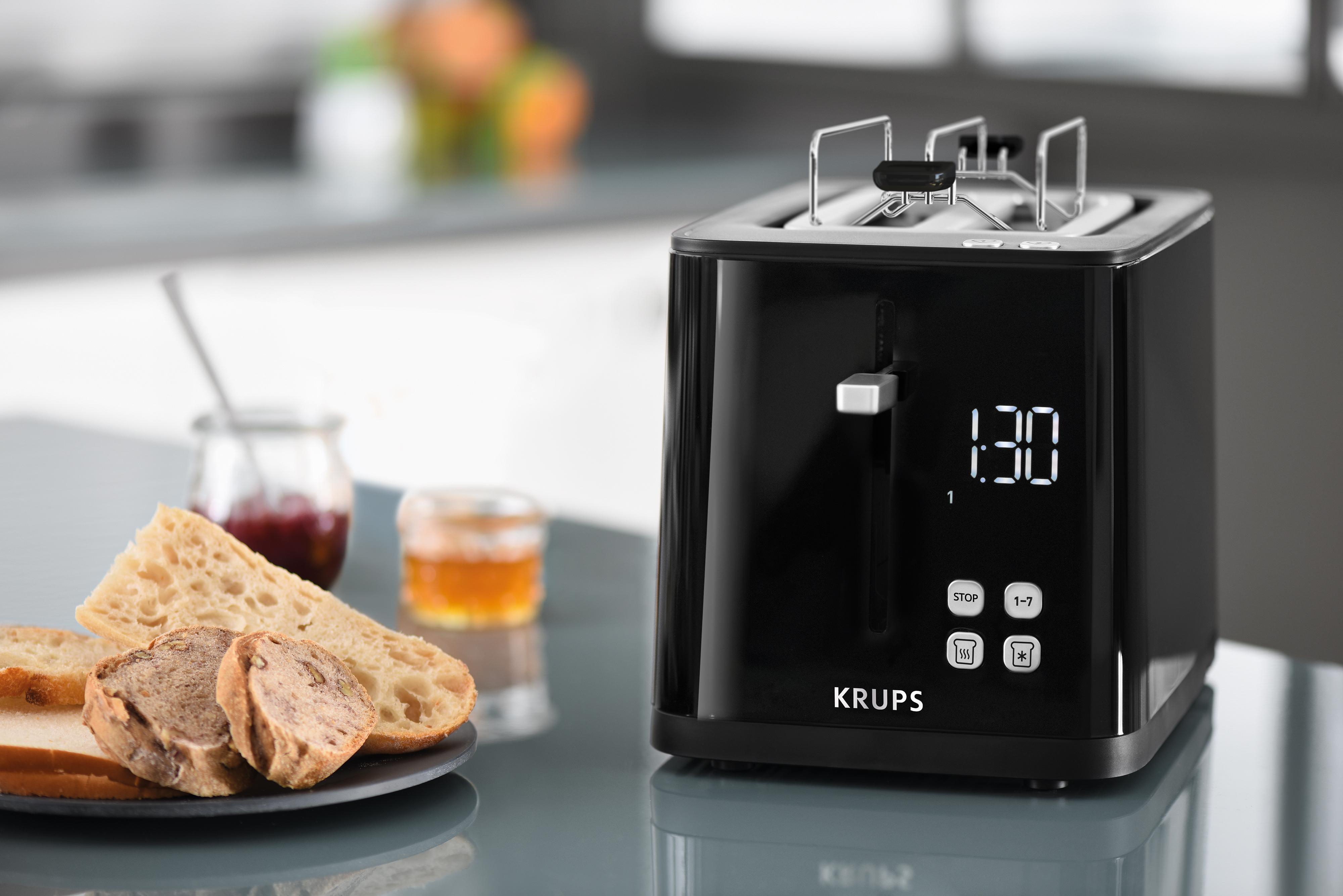 Ein schwarzer Toaster mit Brot und Marmelade. Es hat ein digitales Display.