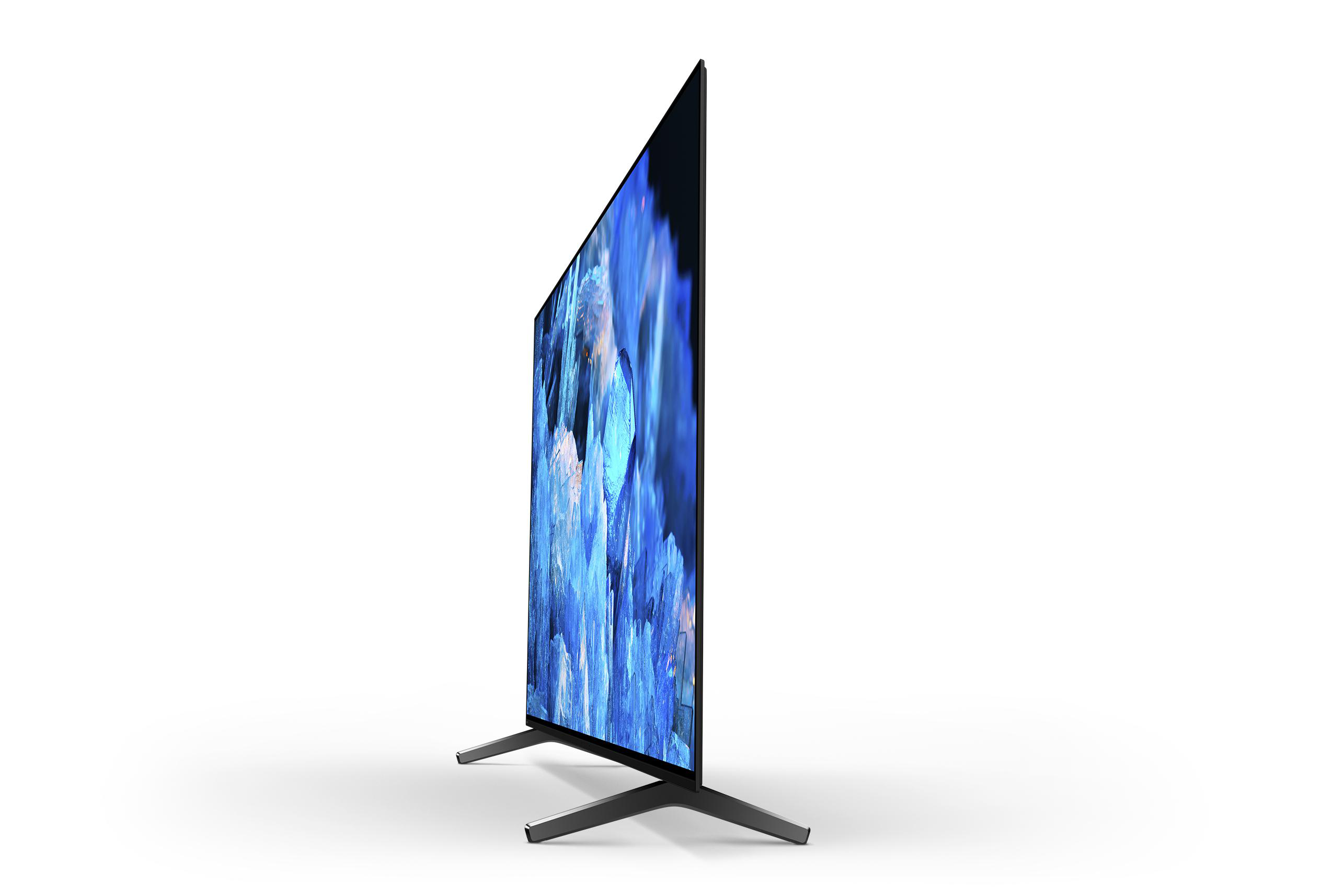 Ein schwarzer Fernseher, der auf weißem Hintergrund steht. Der Bildschirm zeigt ein blau-weißes Bild. Der Fernseher hat einen Ständer.