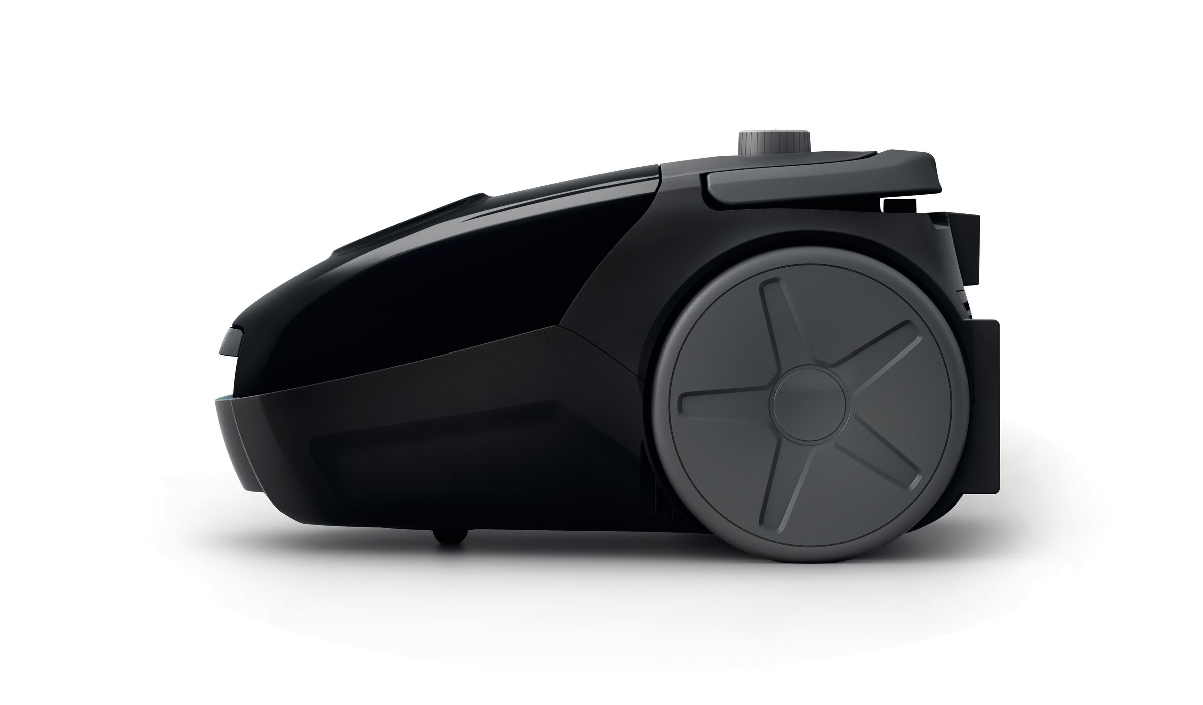 Black vacuum cleaner. The vacuum cleaner is black and has a large wheel.