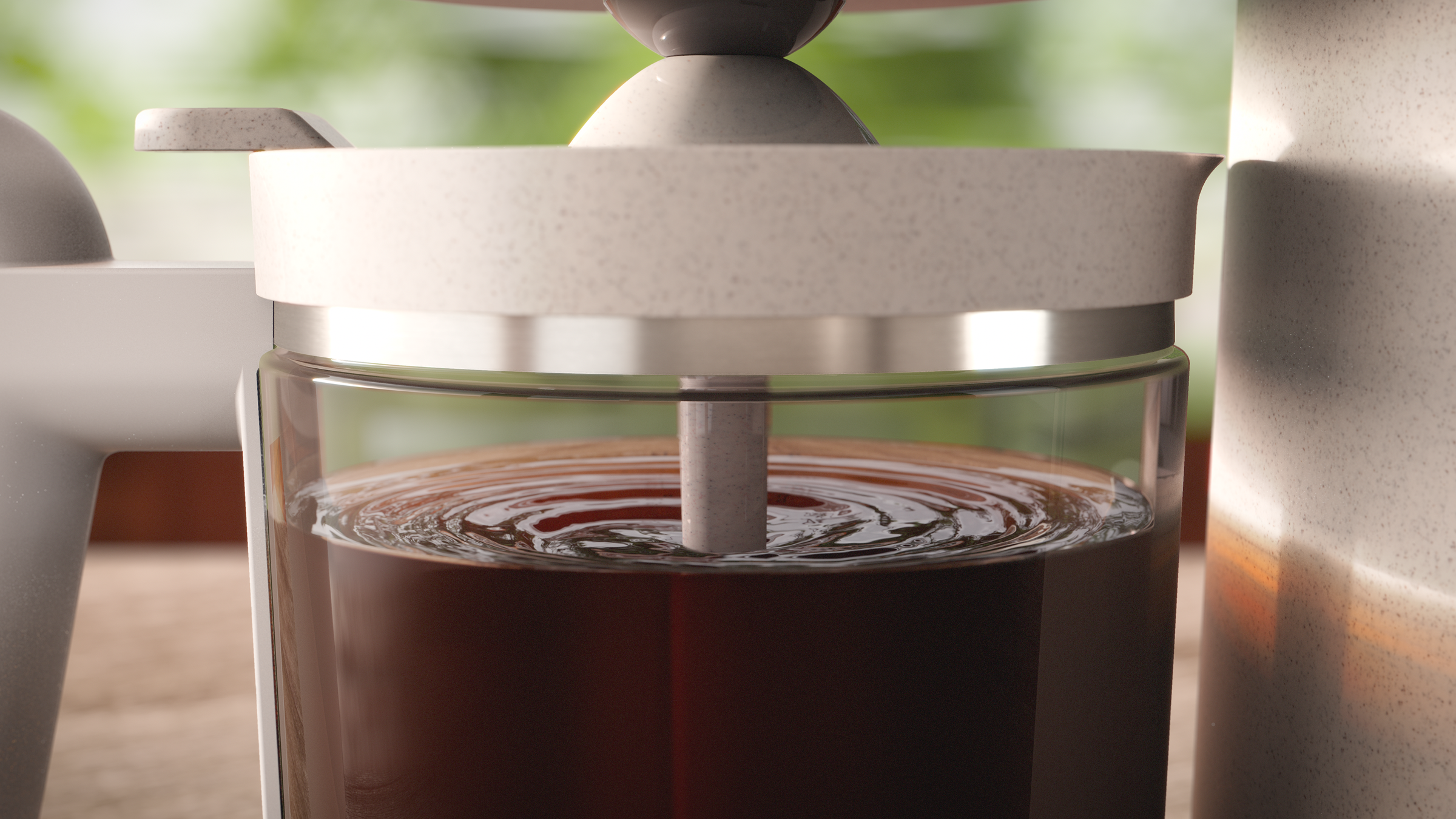 A close-up of a coffee maker with dark brown coffee in the glass container.