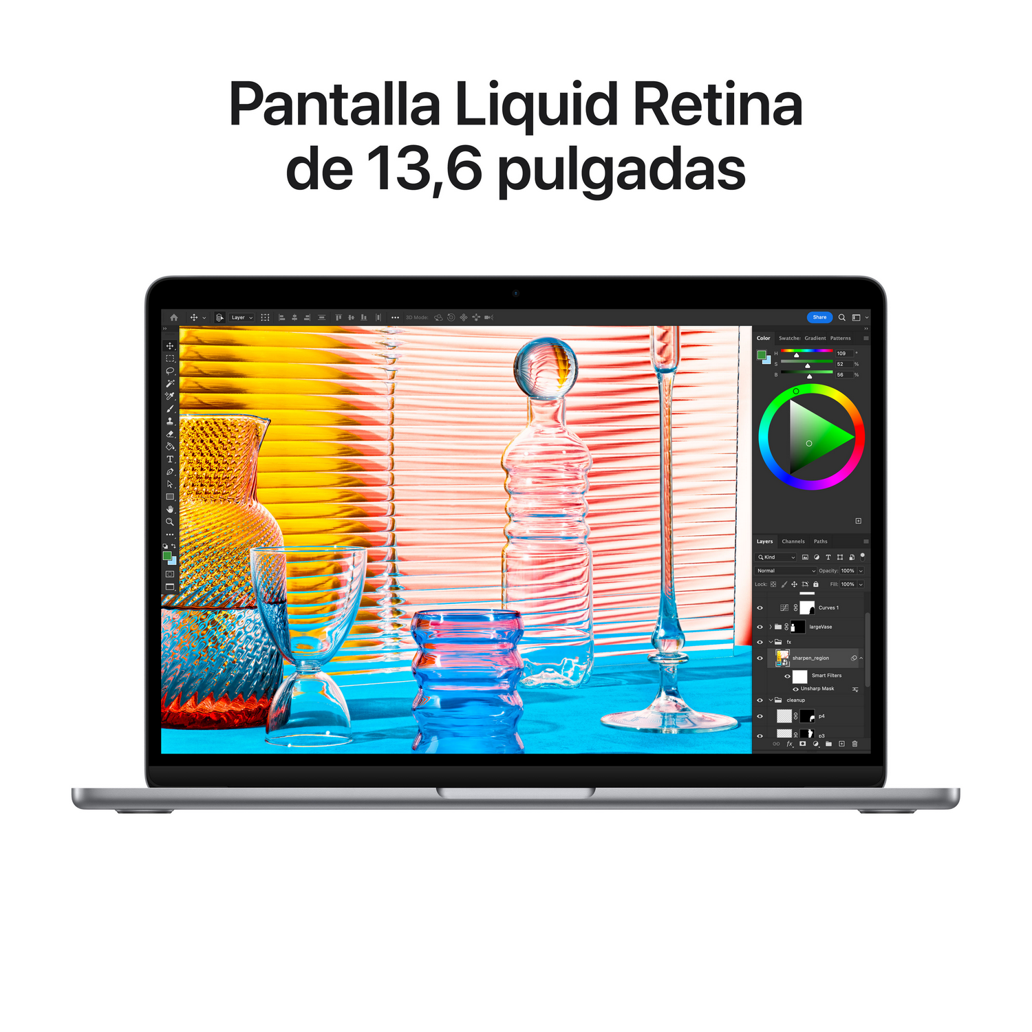 Un portátil plateado con una pantalla colorida que muestra un proyecto de diseño gráfico sobre un fondo blanco.
