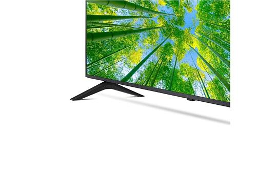 Pantalla de TV con imagen de bosque de bambú, soporte negro, fondo blanco.