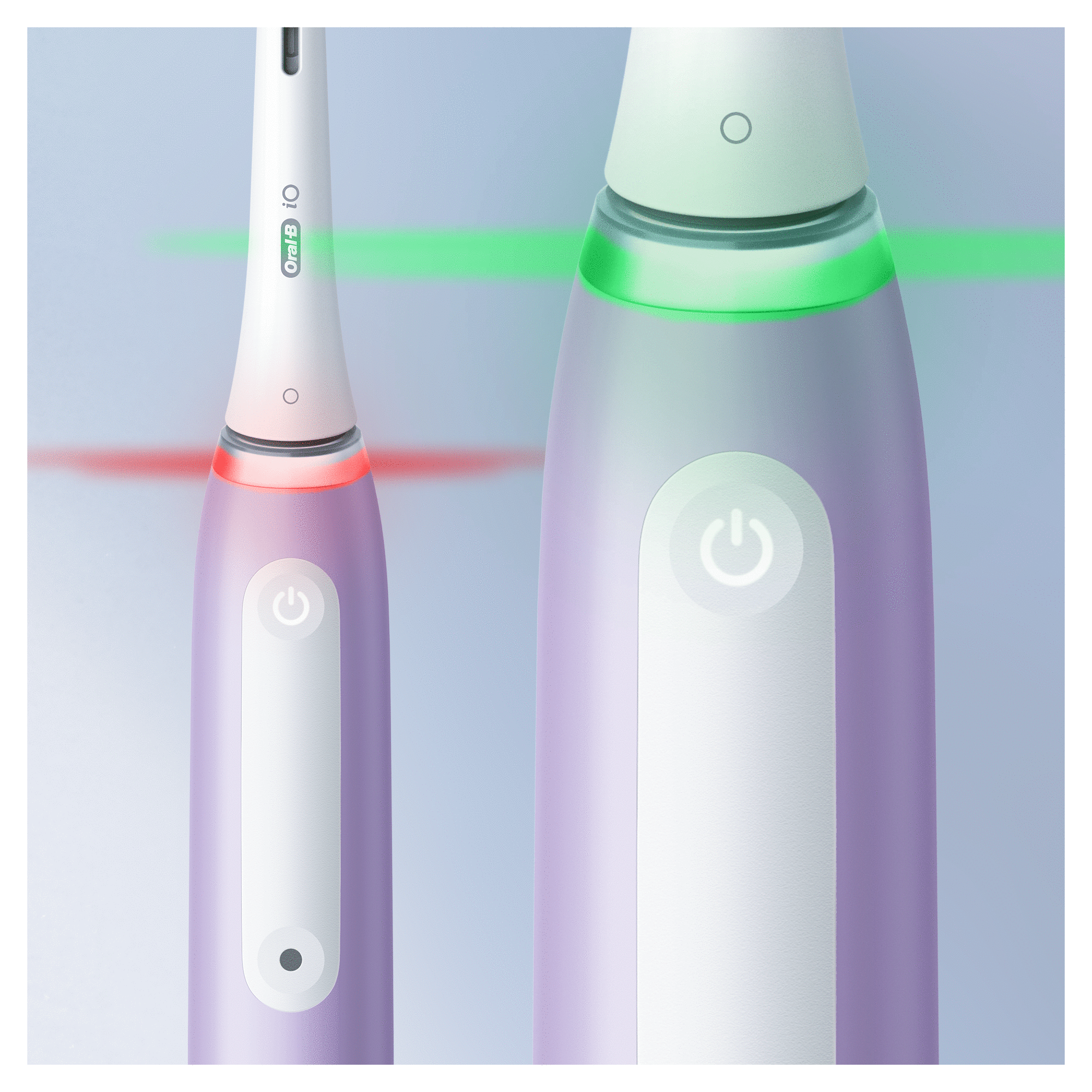 Electric toothbrush with green and red light indicators and a power button.