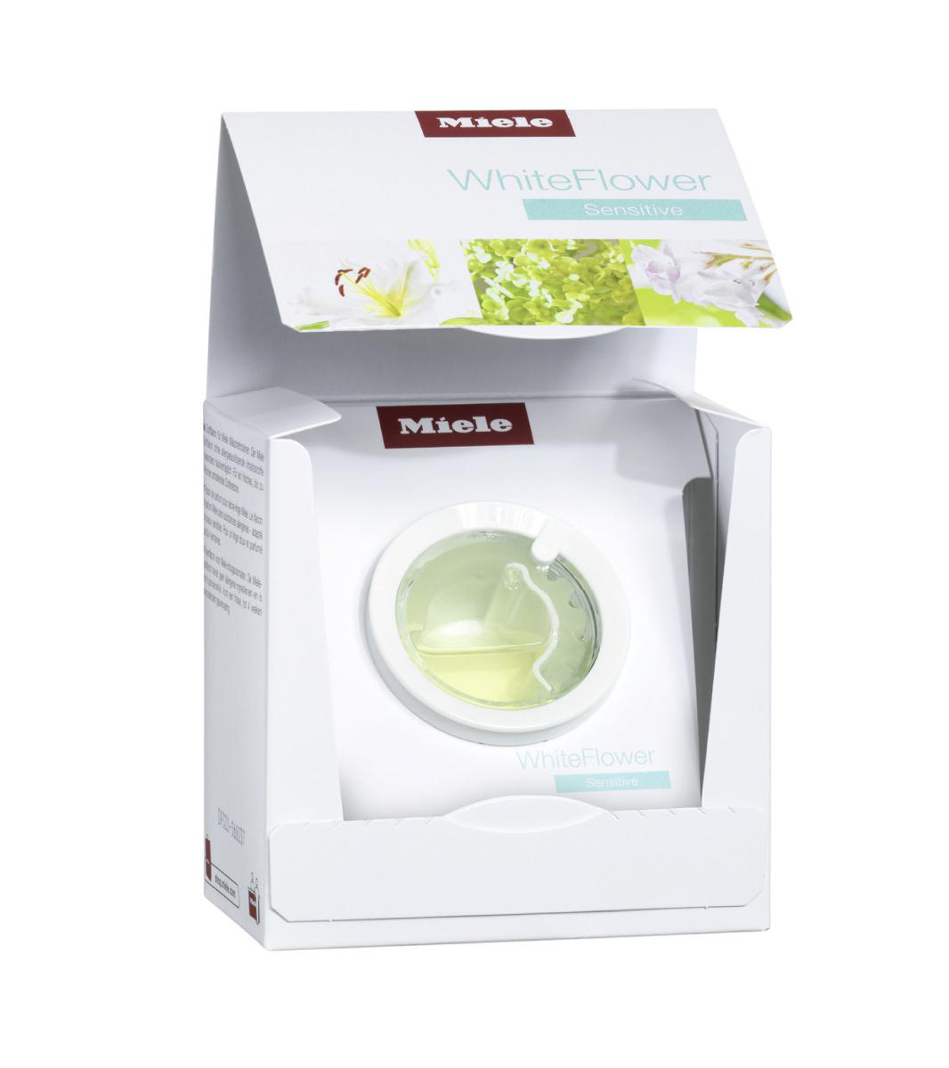 Weiße Box mit transparentem Fach mit einer Flüssigkeitsflasche. Miele-Logo und Produktname sichtbar.