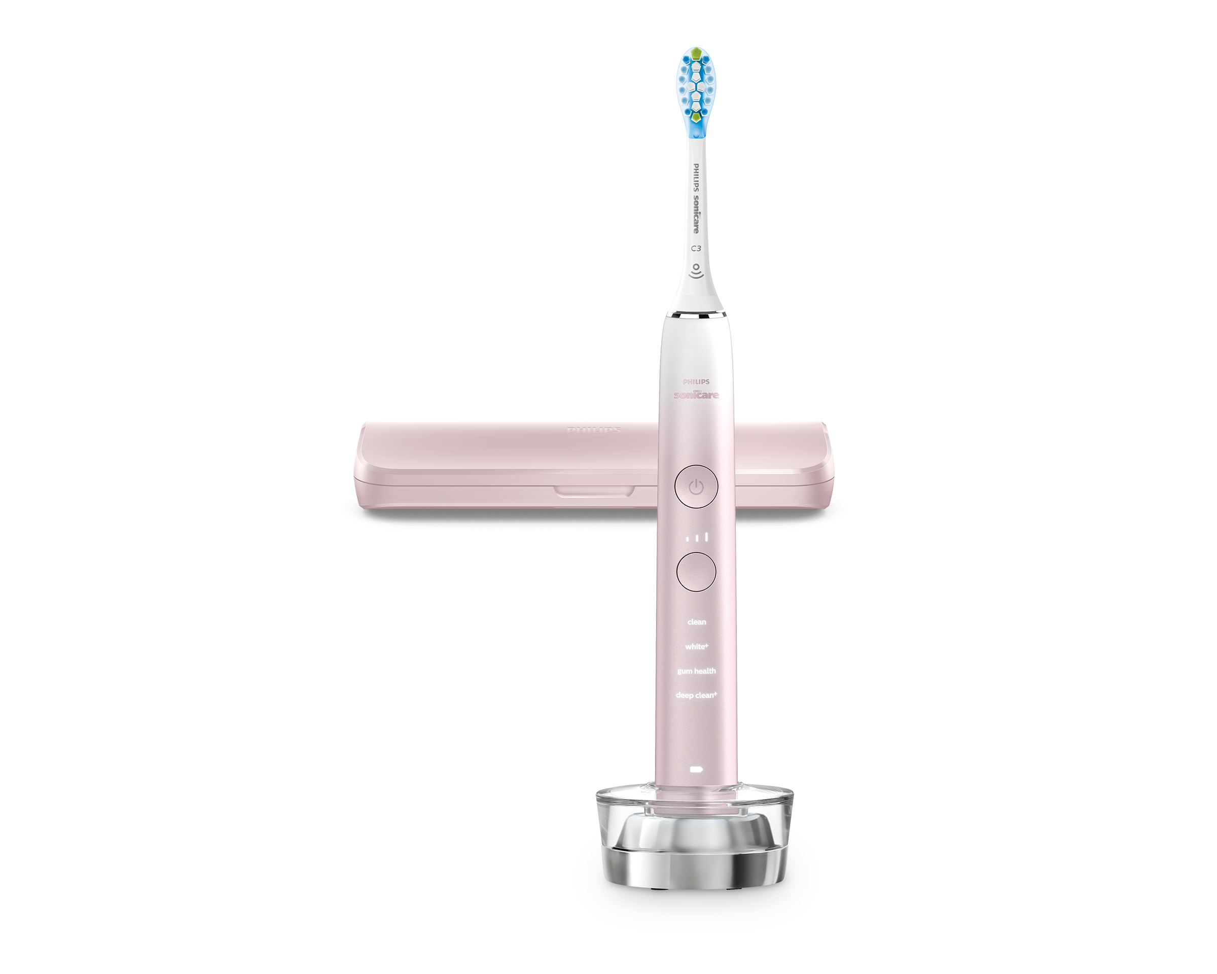 Brosse à dents électrique rose, socle de chargement et étui de voyage sur une surface blanche.