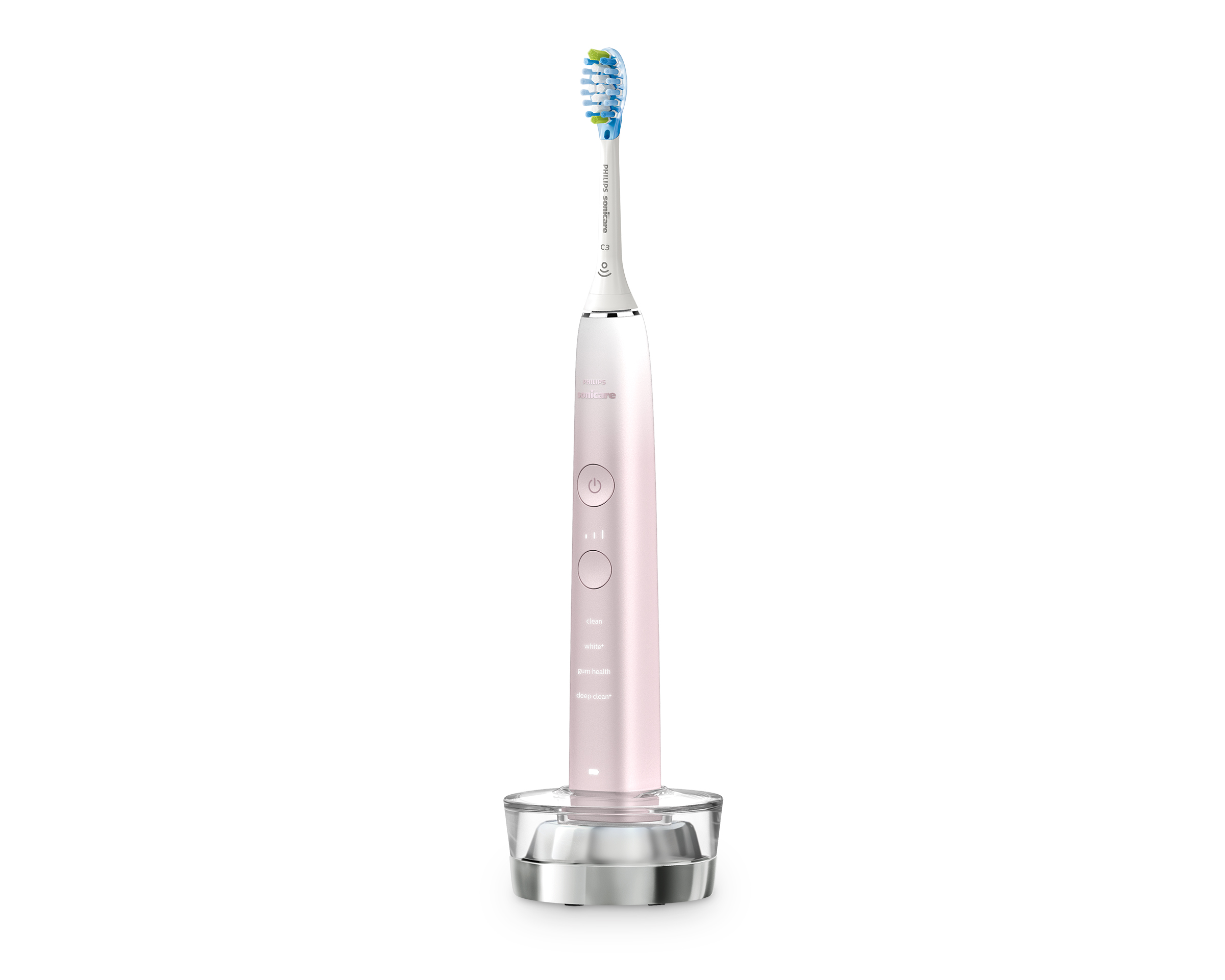 Une main tenant une télécommande Dyson argentée sur fond blanc.