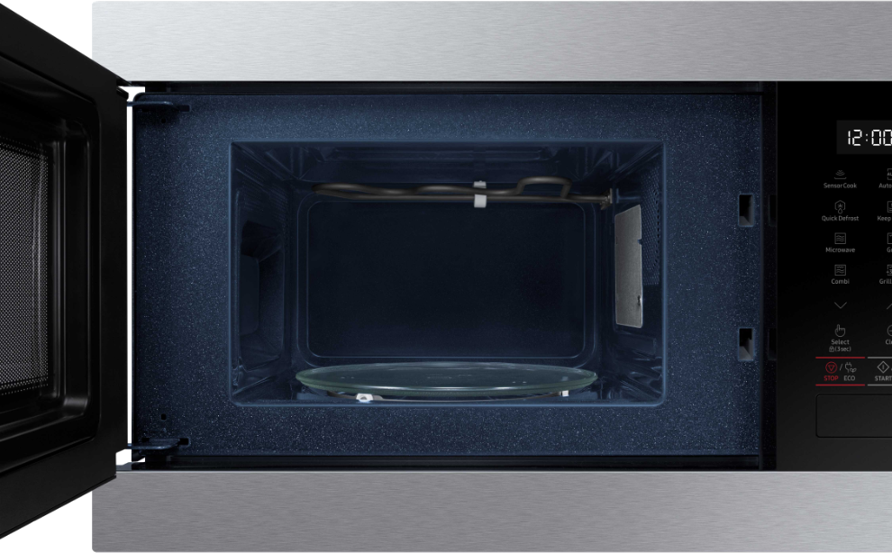 Microwave interior with glass plate and heating element. The door is open.