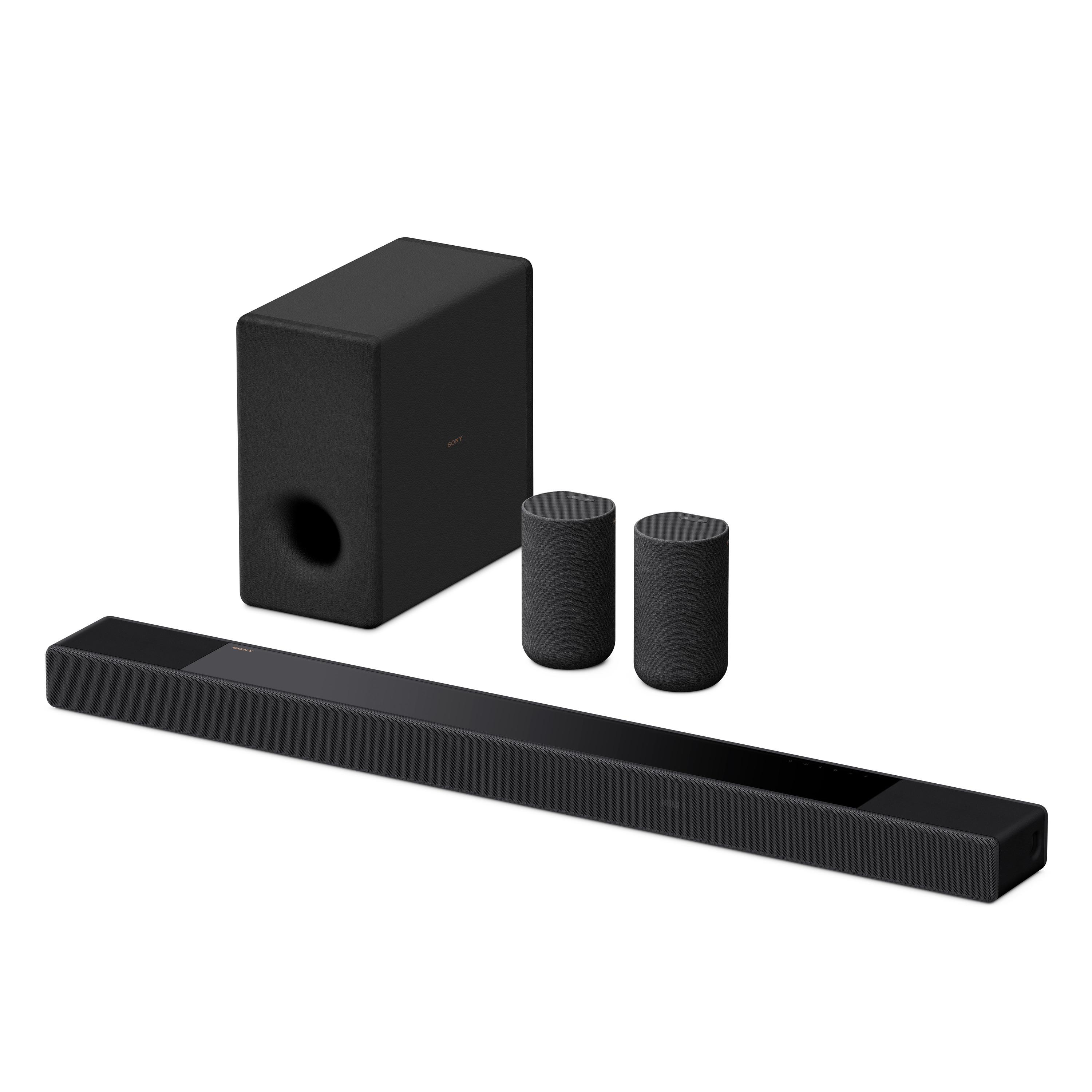 Schwarze Soundbar, Subwoofer und zwei zylindrische Lautsprecher. Alles schwarz und modern.