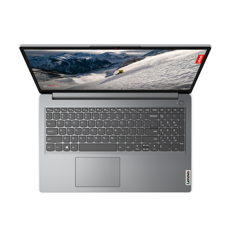 Portátil abierto desde arriba. Muestra teclado y pantalla con escena de montaña nevada.