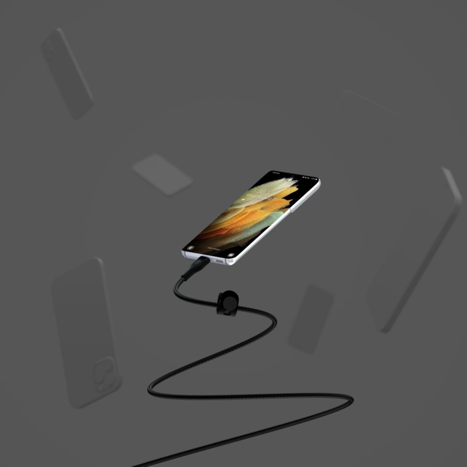 A smartphone is suspended mid-air, connected to a charging cable. Other blurred phones float in the background against a gray backdrop.