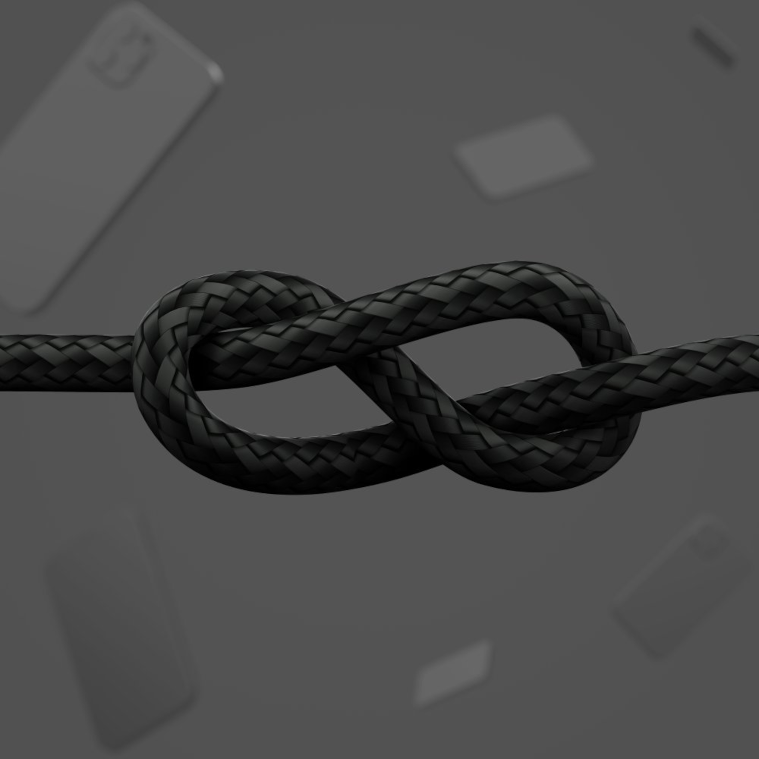 Un câble tressé noir noué. Des smartphones sont flous en arrière-plan, le tout sur un fond gris.