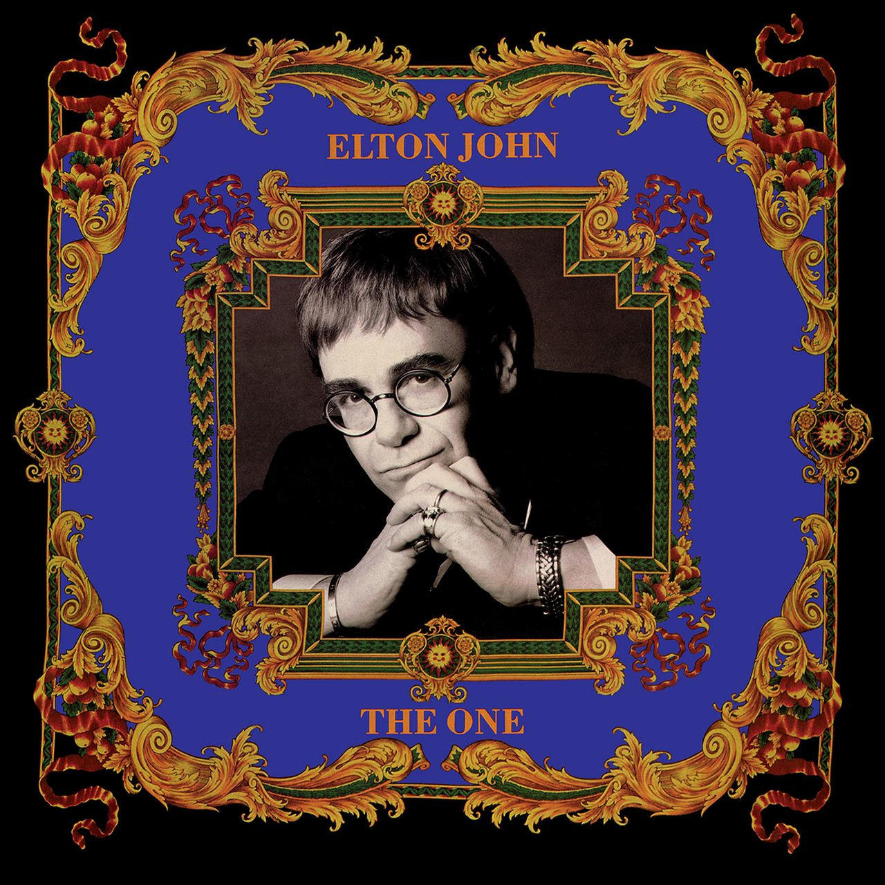 Elton John album borító, fekete-fehér fotó, díszes keret, kék háttér.