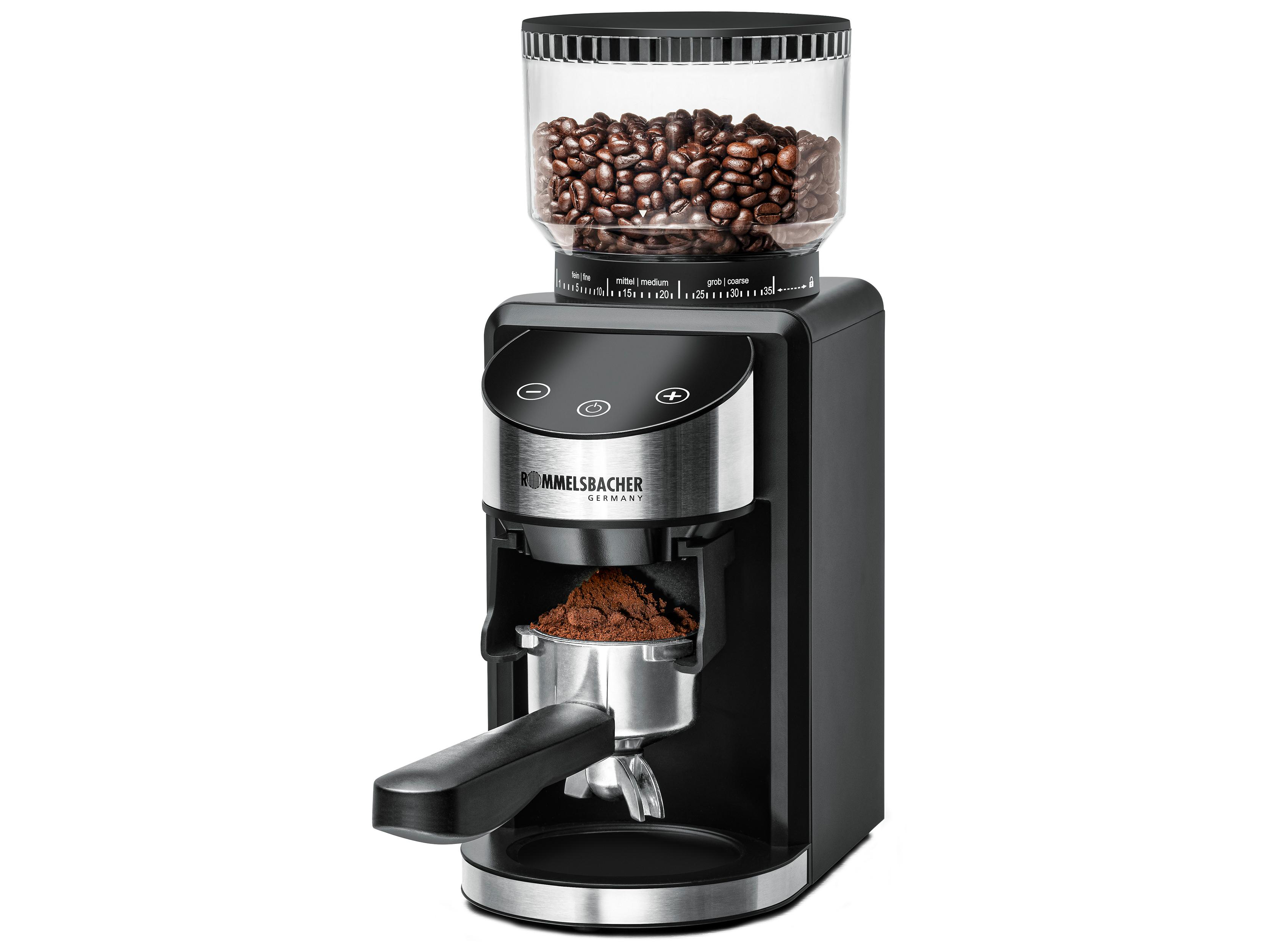 Schwarze und silberfarbene Kaffeemühle mit Kaffeebohnen im Behälter und gemahlenem Kaffee.