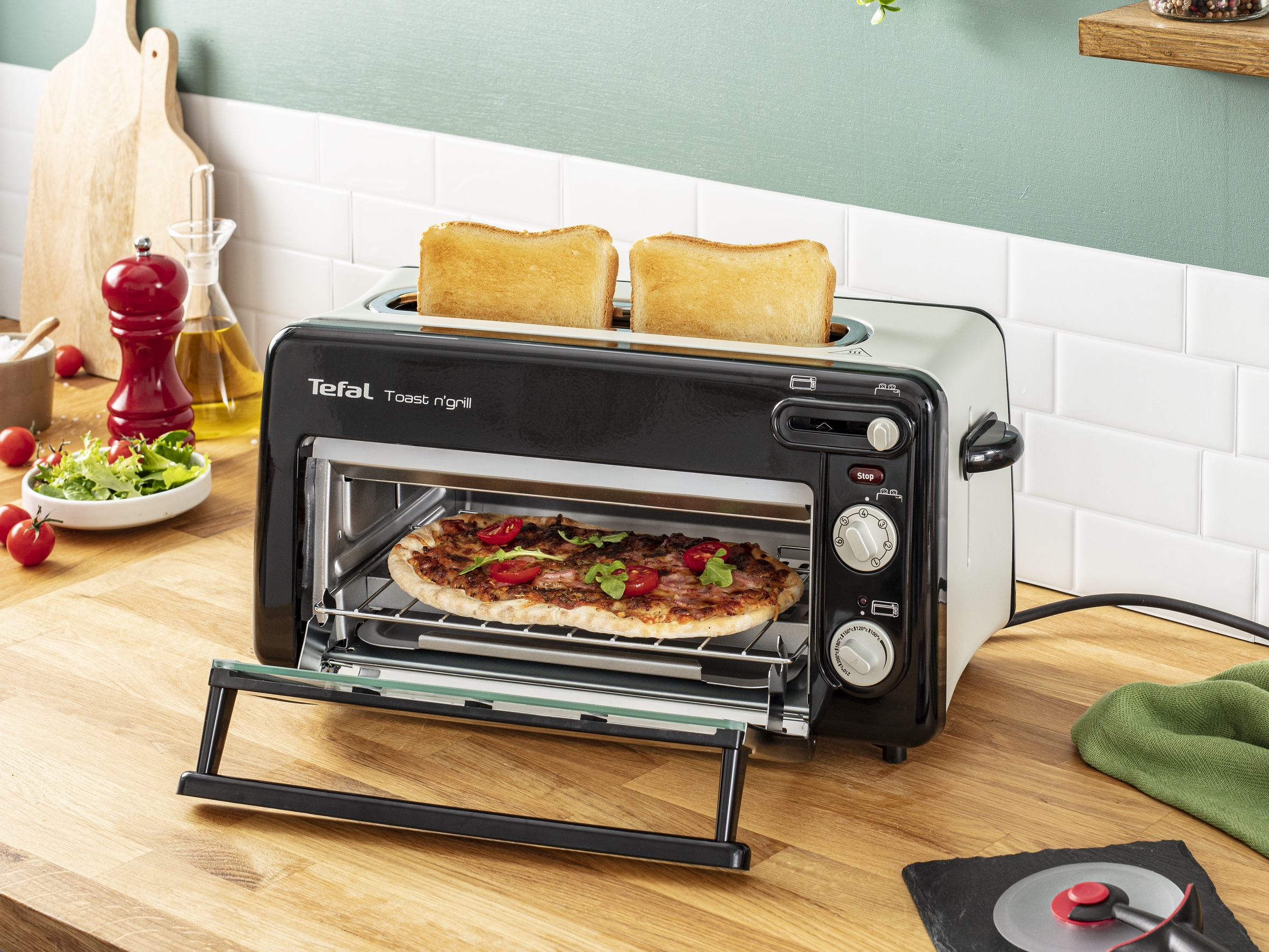 Pizza en un horno tostador con tostadas encima. Ambiente de cocina.
