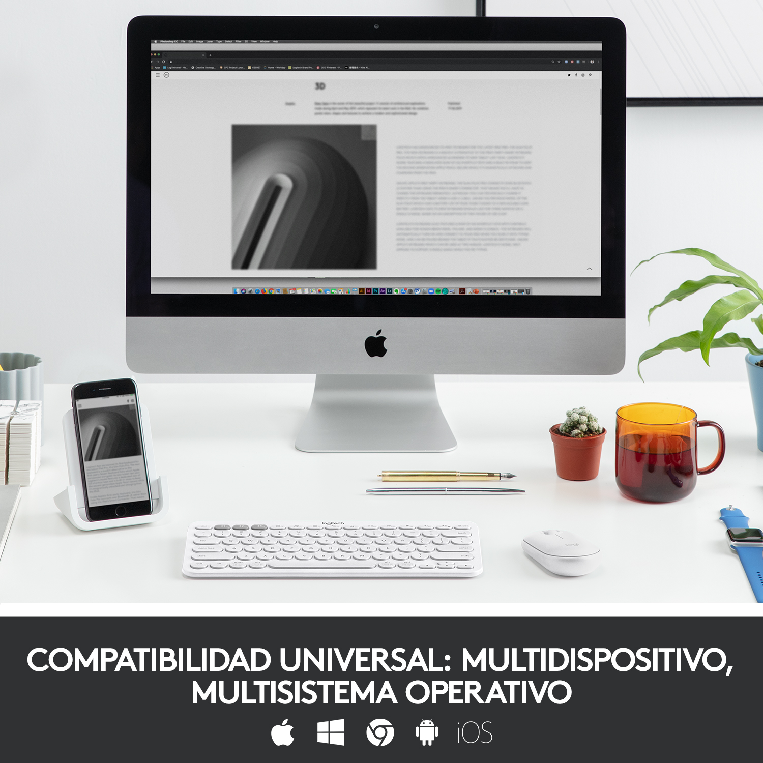 Una configuración de escritorio con una computadora, teléfono, ratón, teclado y una taza de té.