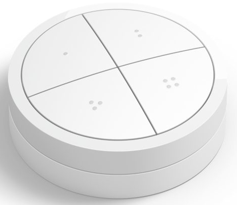 Bouton de maison intelligente blanc avec quatre sections, chacune avec un petit indicateur.