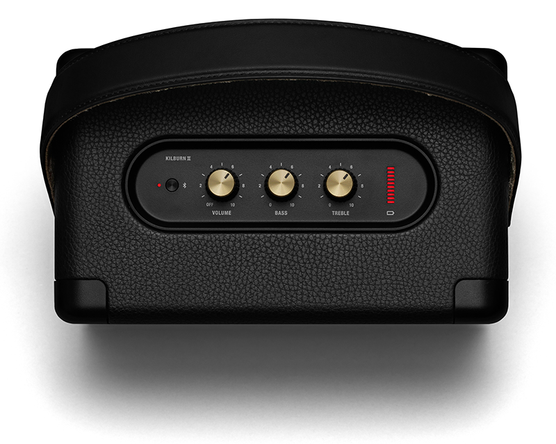 Black Marshall speaker with gold knobs and controls on top, isolated on white.