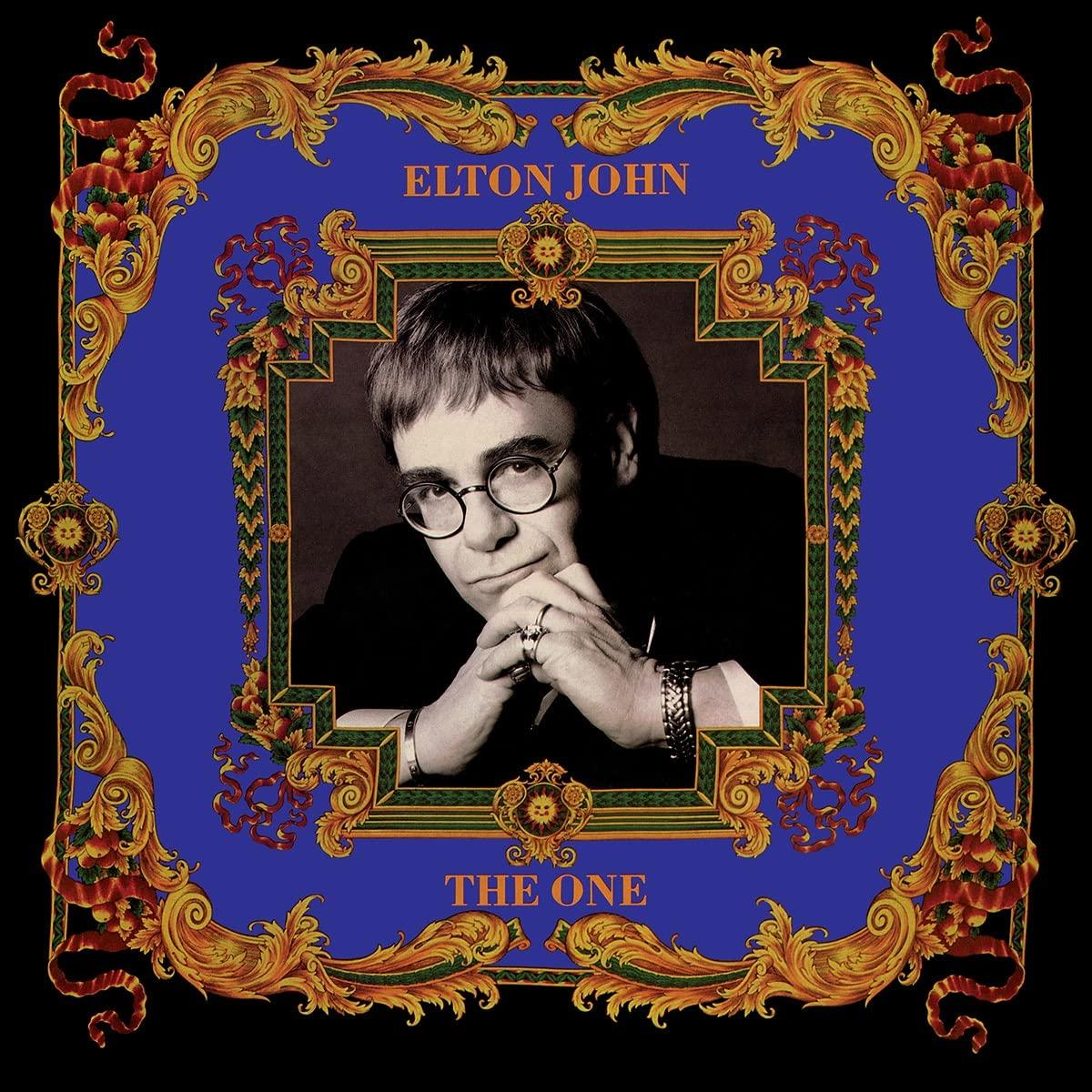 Album borító Elton Johnnal, kék háttérrel és díszes arany kerettel.