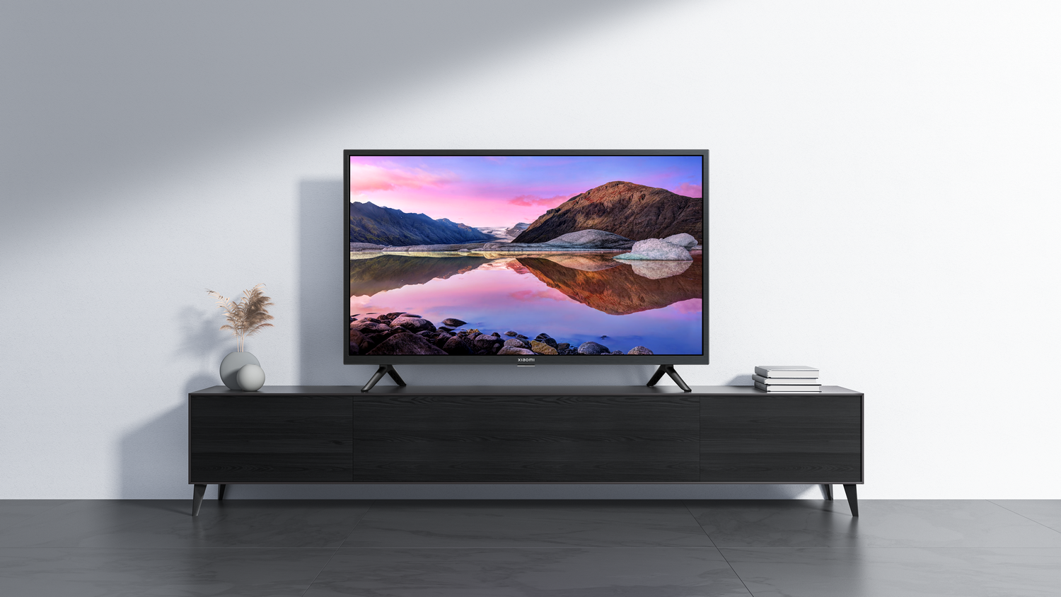 Un televisor en un mueble con un reflejo de un paisaje en la pantalla.