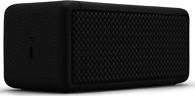 A black speaker with a textured front, angled to the left.