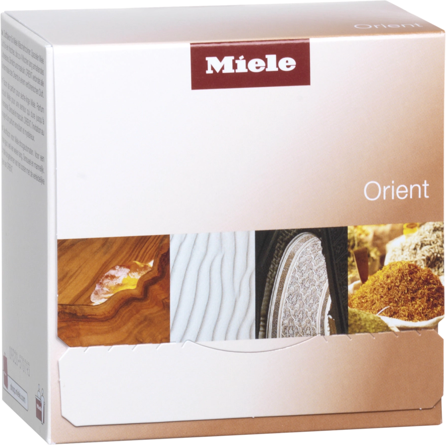 Miele Orient laundry detergent box with images of wood, sand, and patterns.