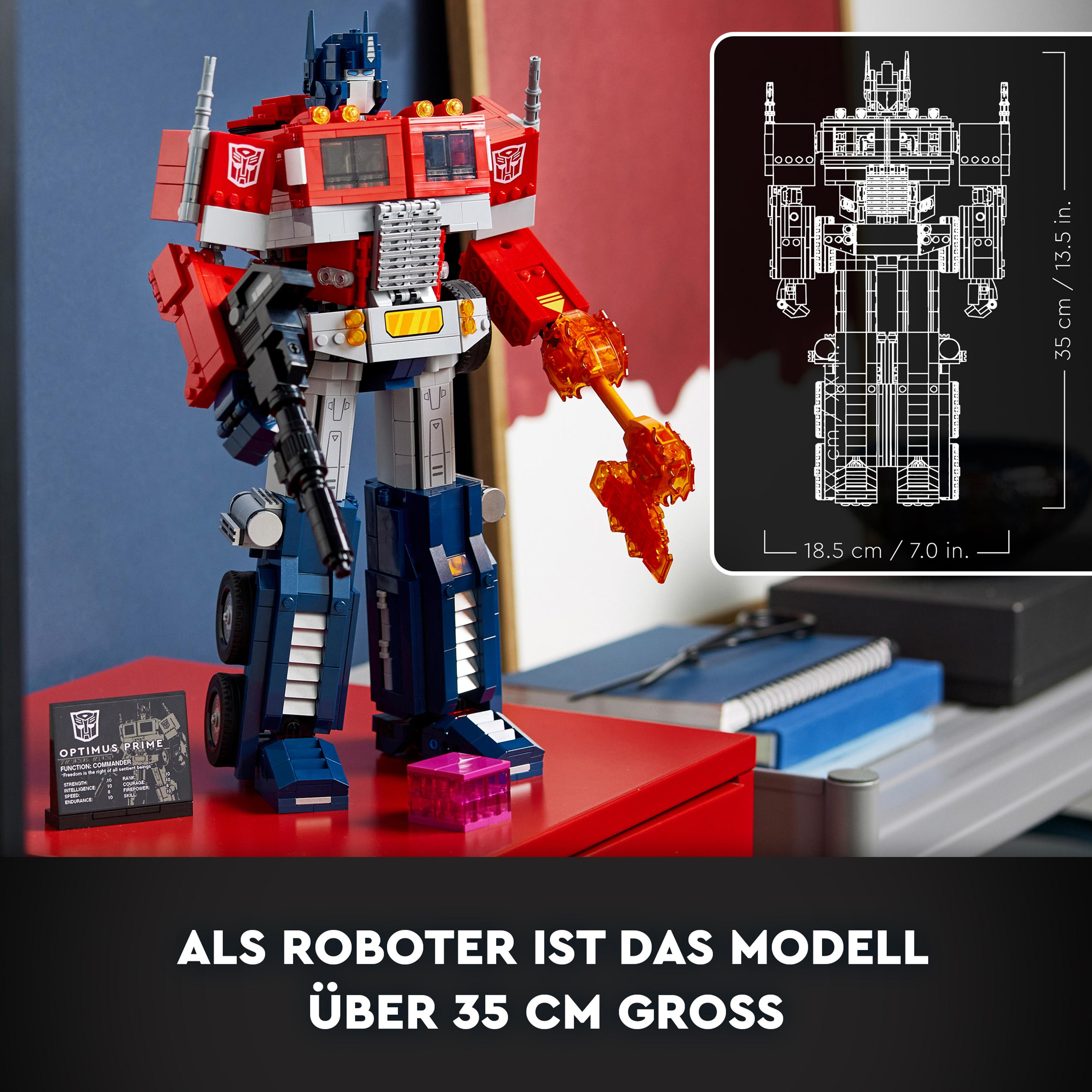 Optimus Prime Lego-Set, mit einem Roboter und seinem Bauplan auf roter Oberfläche.