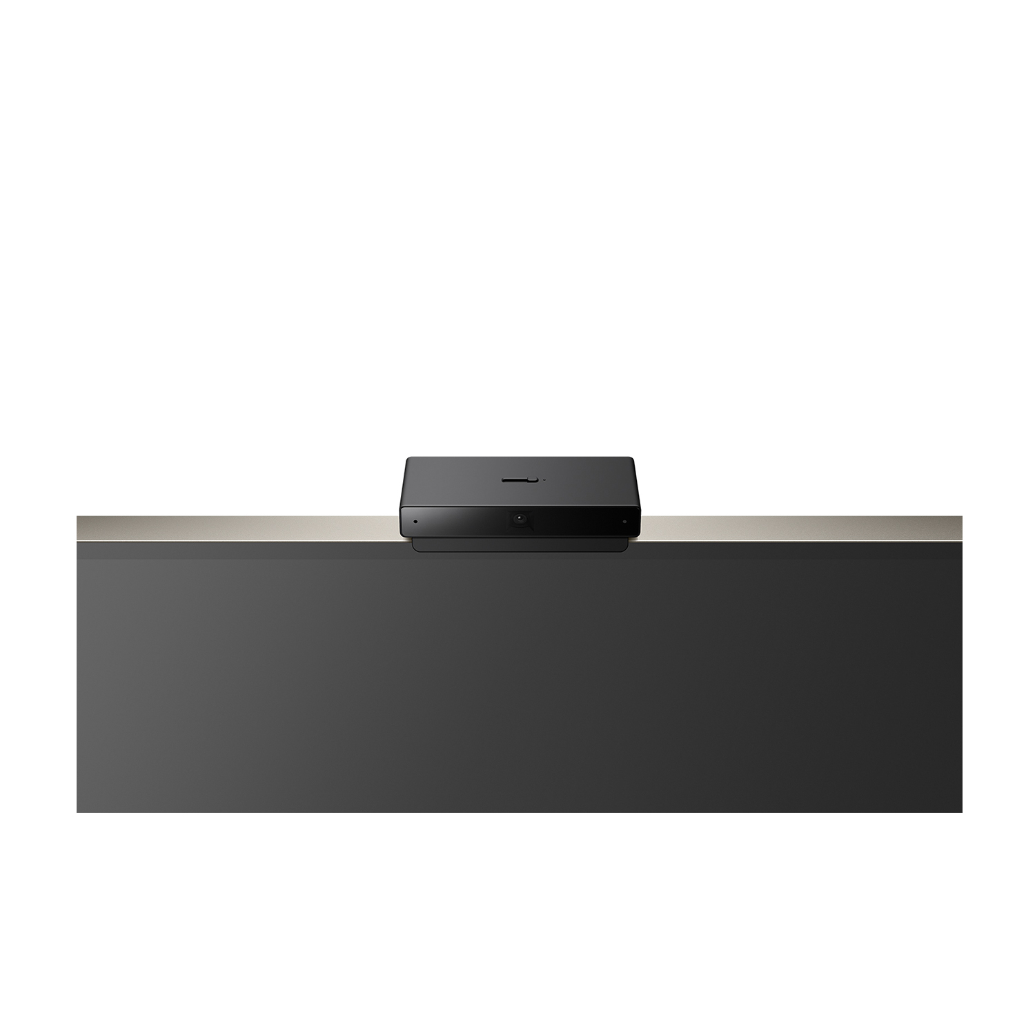 Dispositivo nero su una superficie grigia, probabilmente una webcam, su sfondo bianco.