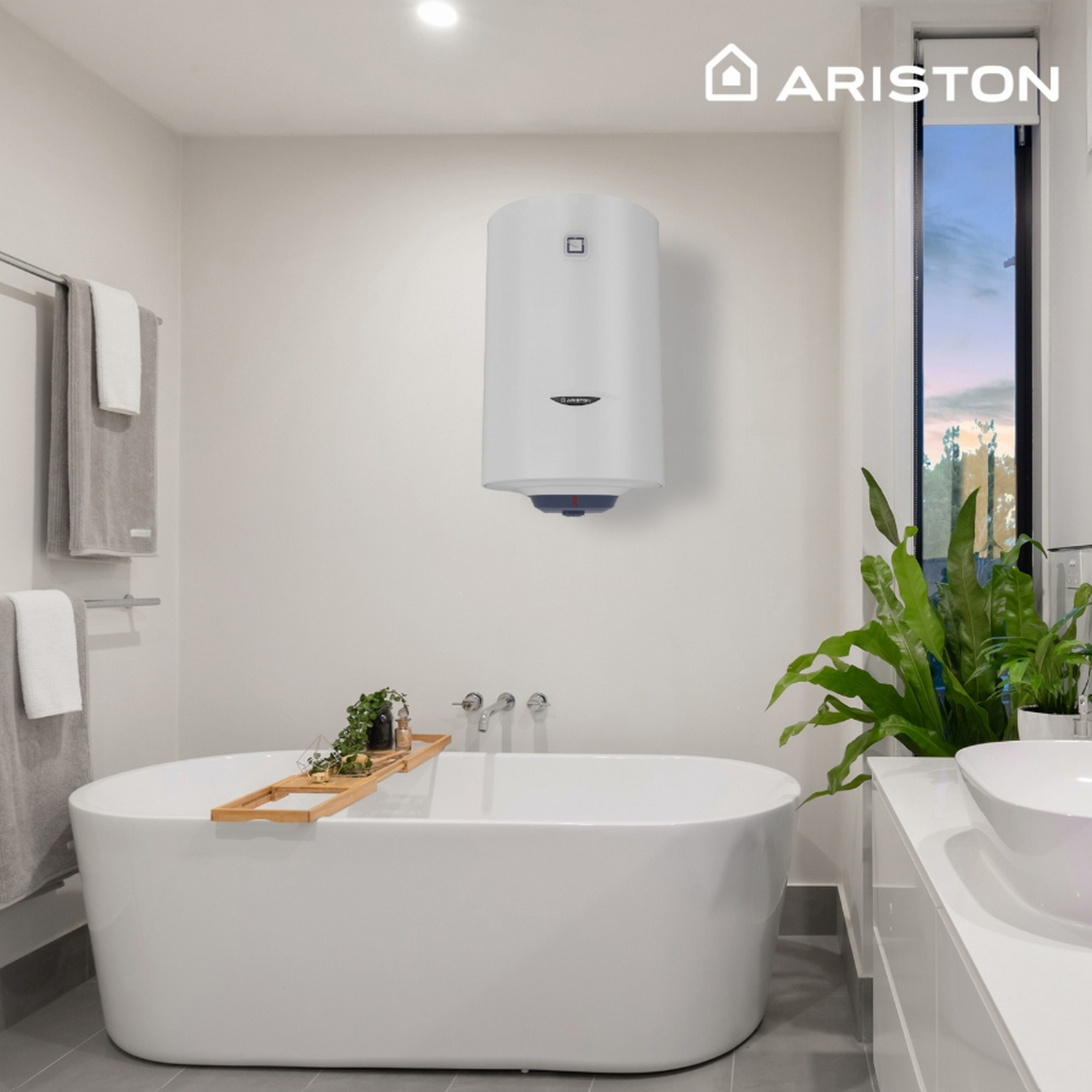 Baño blanco con bañera, calentador de agua y plantas. Ventana en el fondo.