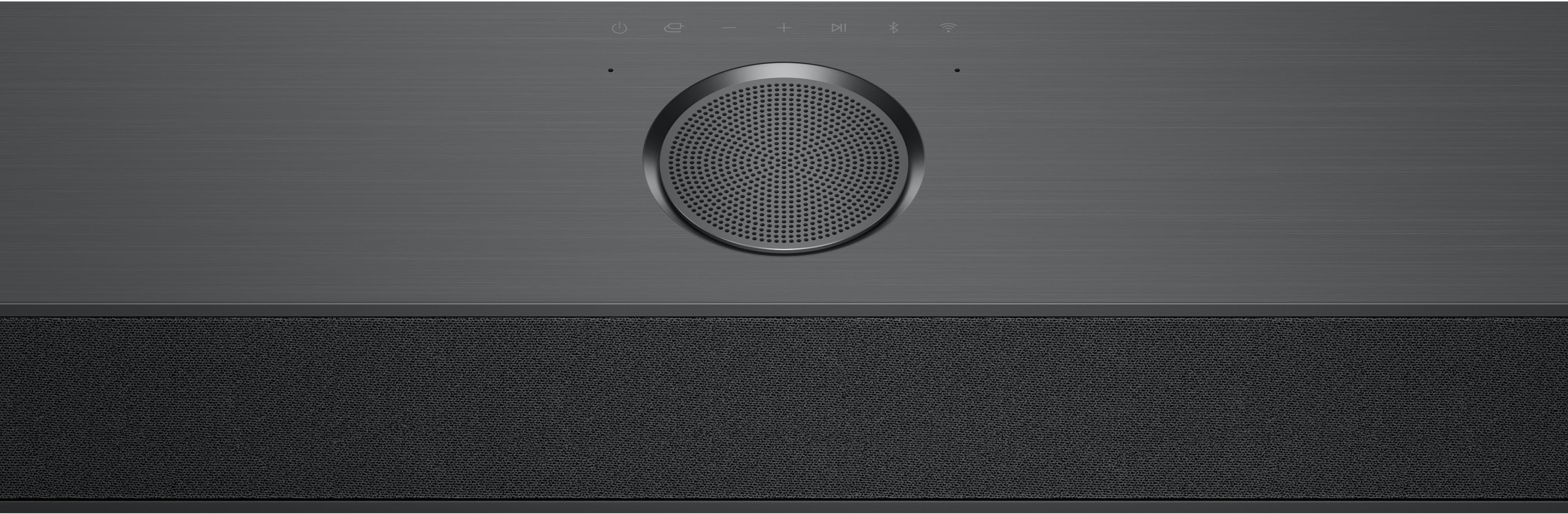 Dunkelgraue Soundbar mit Lautsprechergitter und schwarzem Stoffteil. Bedienelemente oben.