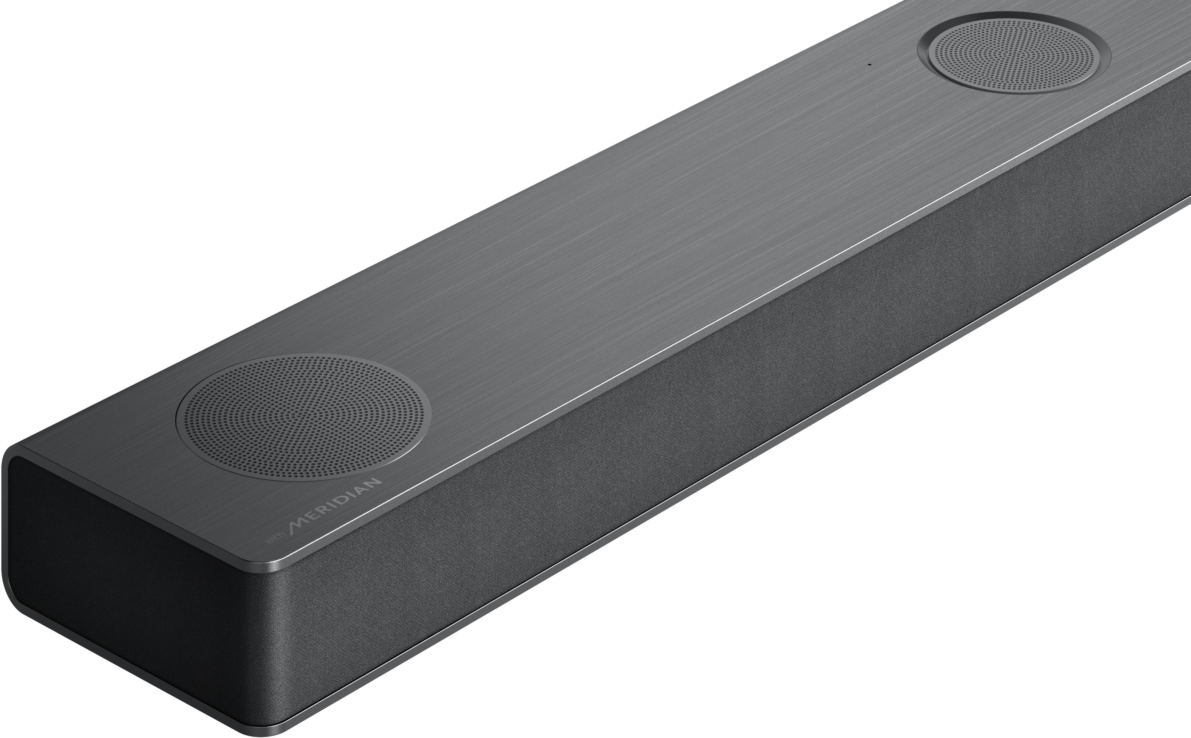 Dunkelgraue Soundbar. Zwei Lautsprecher oben. Meridian-Logo sichtbar. Schlankes Design, metallisches Finish.