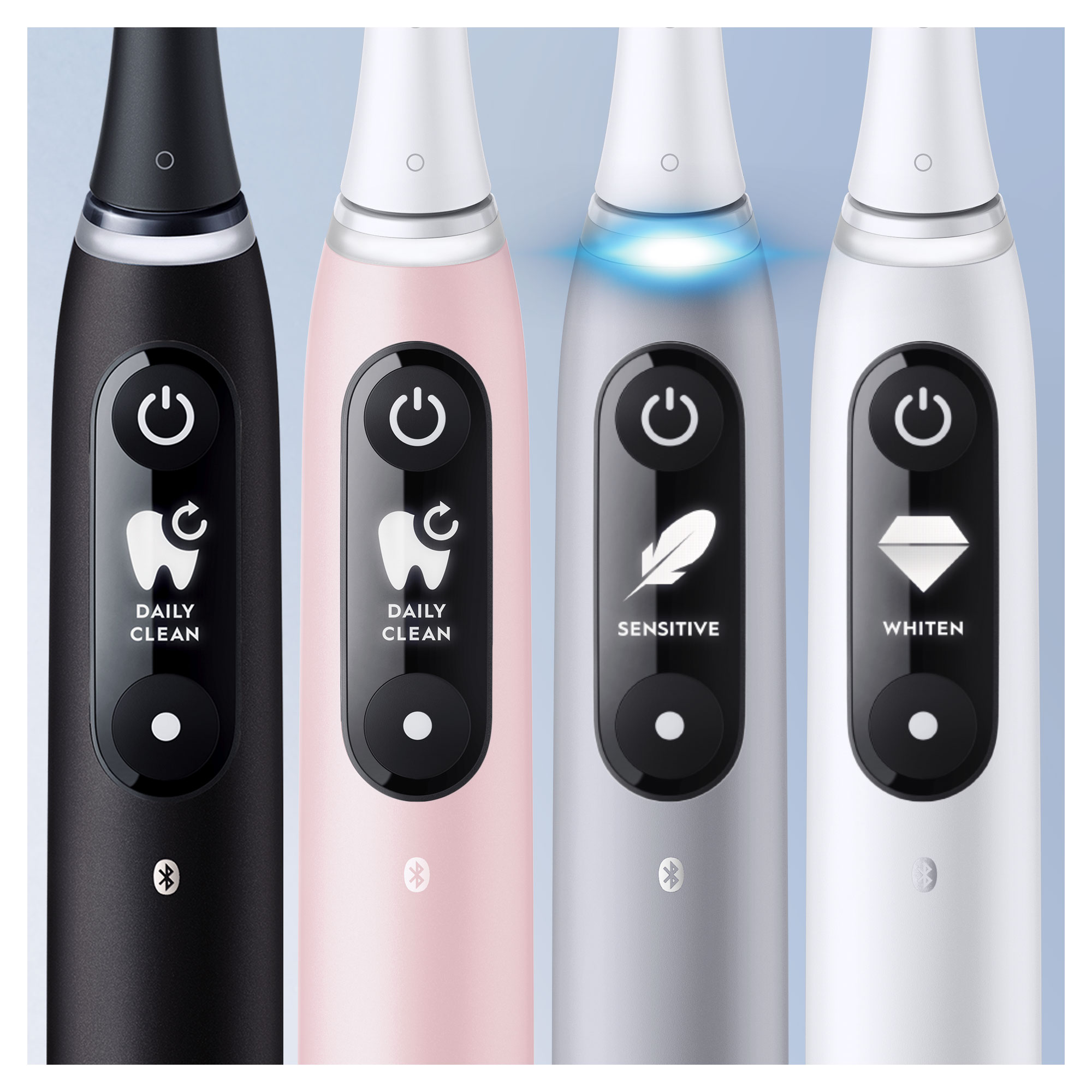 Cuatro cepillos de dientes eléctricos Oral-B con botones de diferentes colores. Cada uno tiene un icono de encendido.