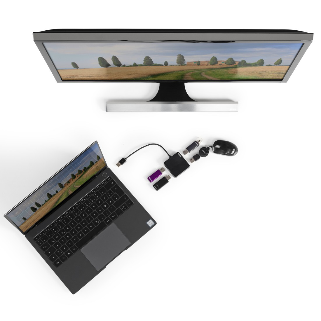 Ordenador portátil conectado a monitor, con periféricos como ratón, concentradores USB y memorias USB. Fondo blanco.