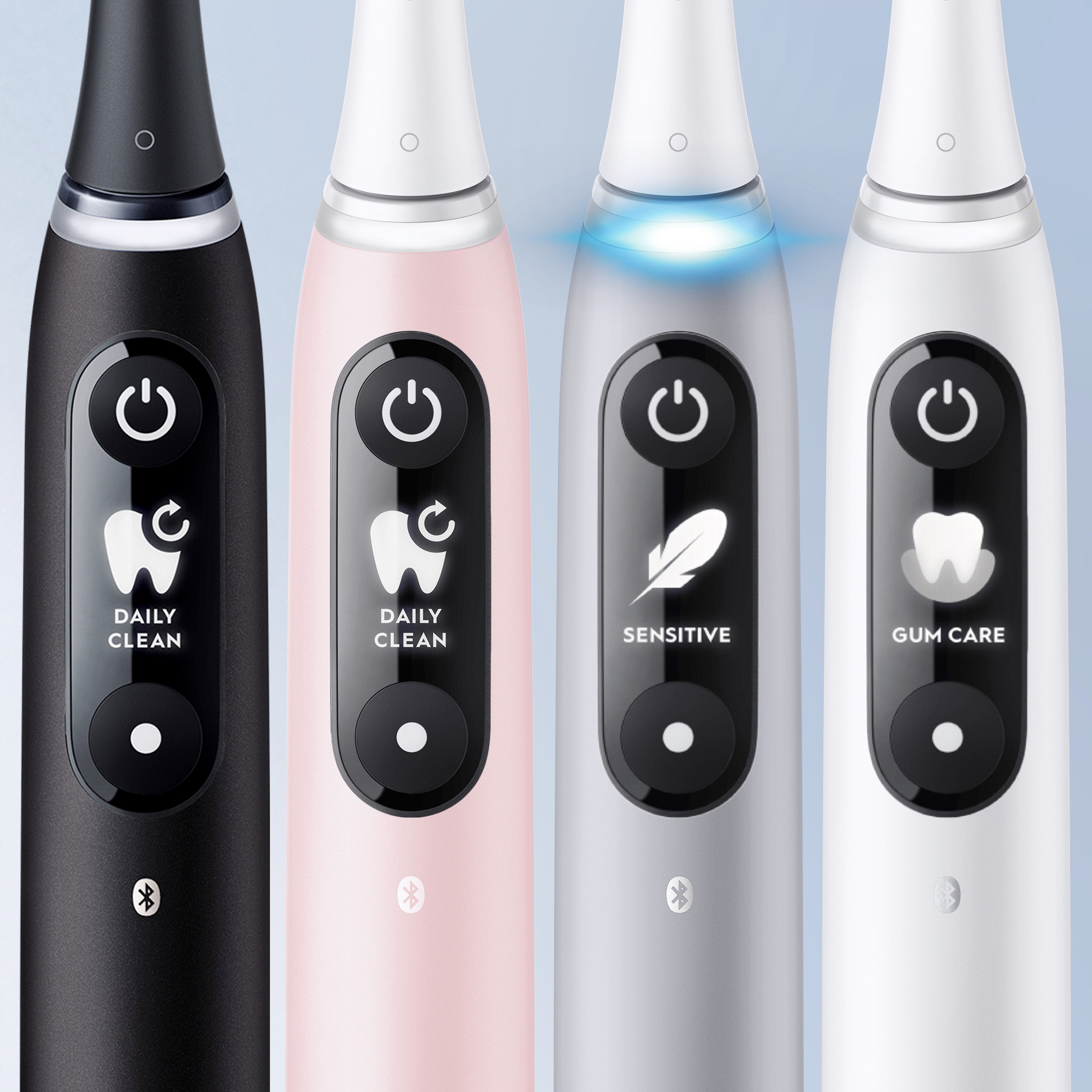 Quattro spazzolini elettrici: nero, rosa, argento e bianco, con diverse modalità.