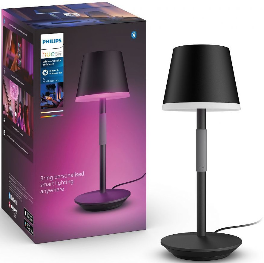 Black and white lamp with a black shade and a box with a pink and white color.