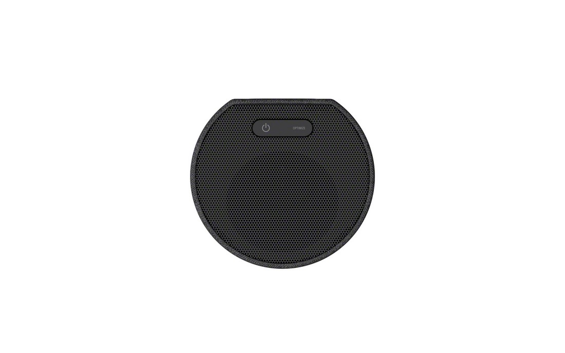 Altavoz negro, forma circular, con botón de encendido/apagado arriba. Fondo blanco.