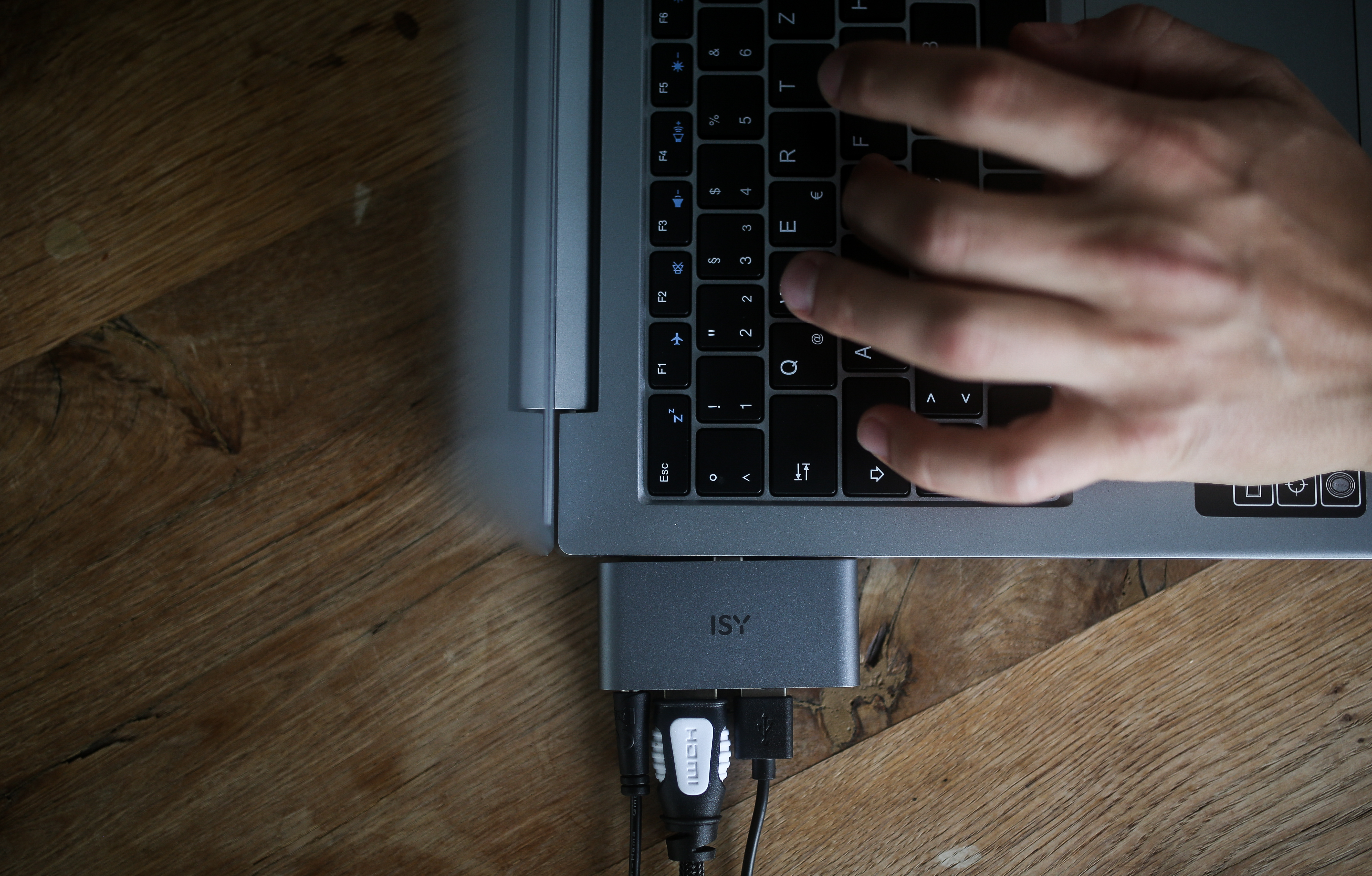 Die Hände einer Person tippen auf einer Laptop-Tastatur.