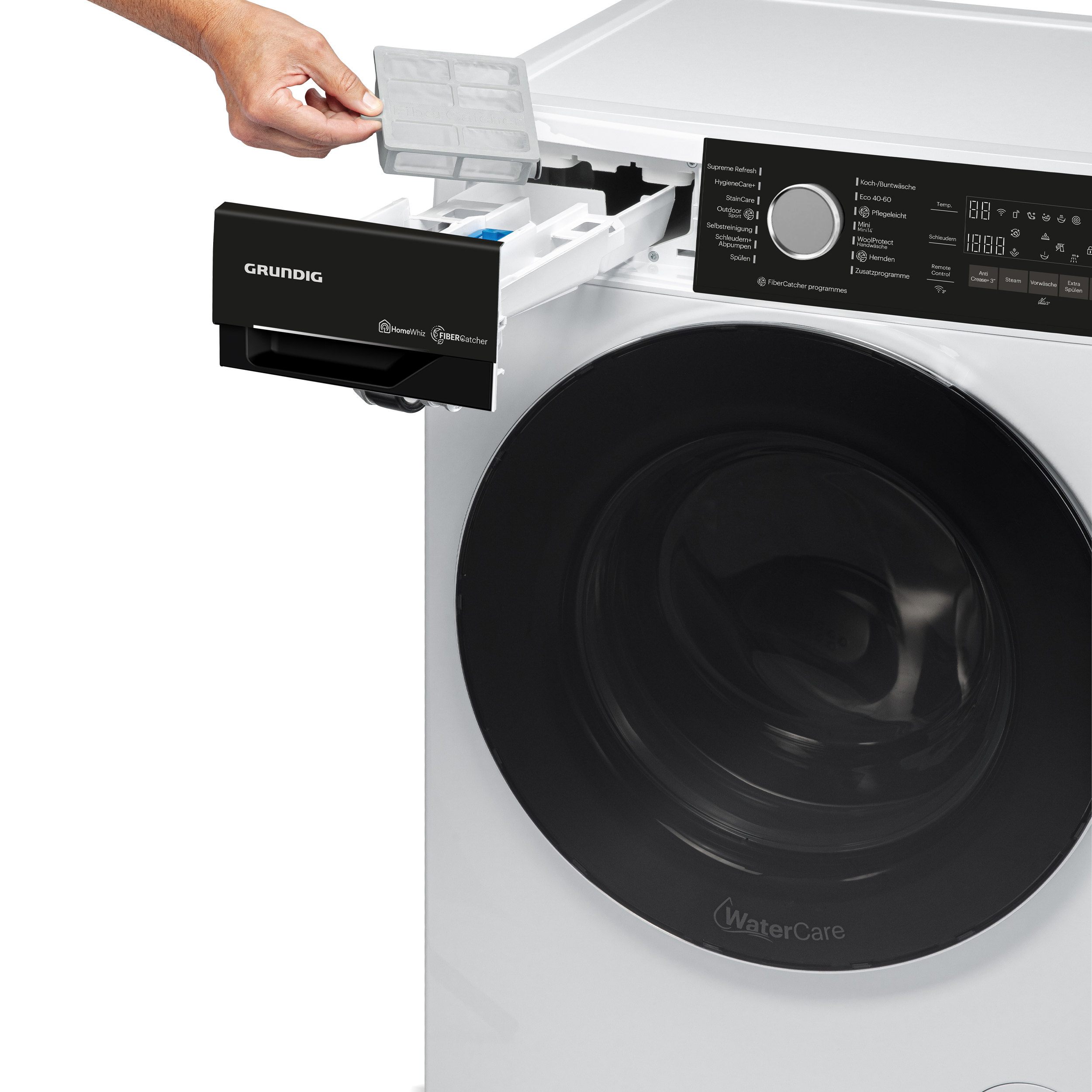 Hand öffnet Waschmittelschublade einer weißen Grundig-Waschmaschine.