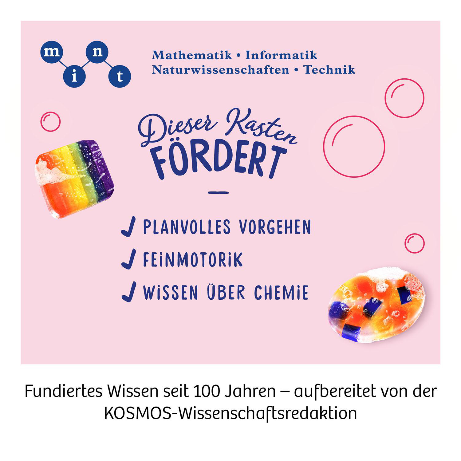 Lernspielzeugbox mit bunten Bonbons und Text. 'Dieser Kasten FORDERT'. Weißer Hintergrund.