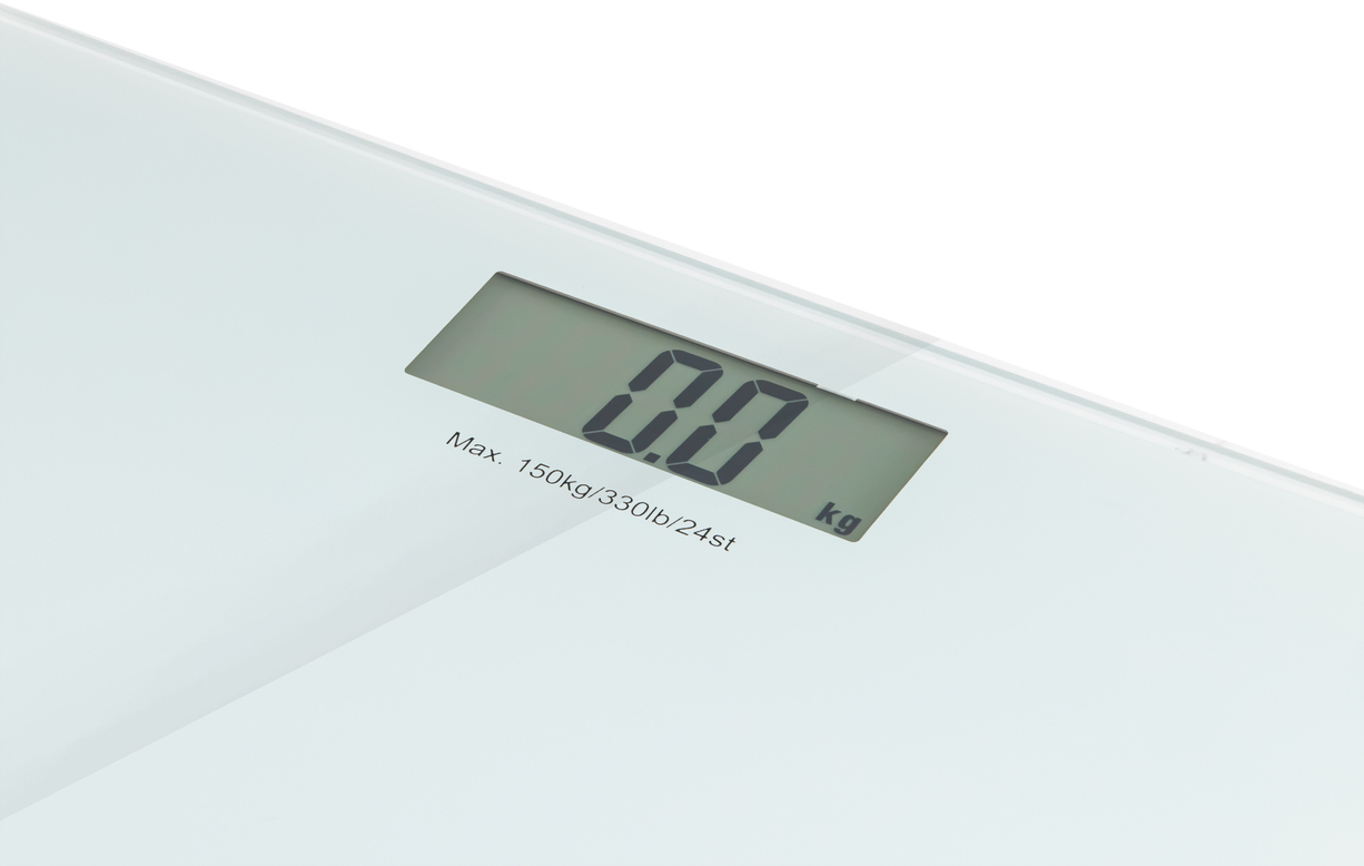 A digital scale displaying "0.0 kg". White background. 