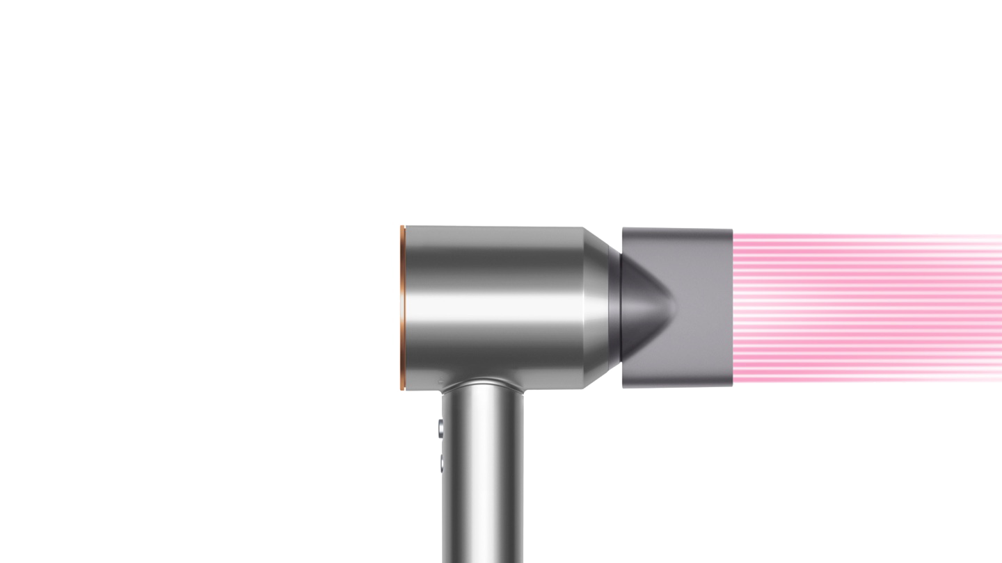 Close-up van een zilveren föhnmondstuk met roze luchtuitlaten.