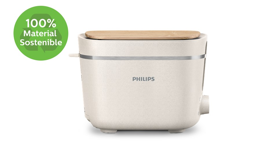 Tostadora blanca con tapa de madera y la palabra "PHILIPS". Etiqueta verde: 100% Material Sostenible.