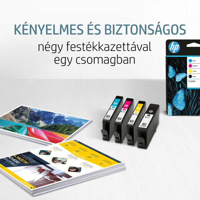 Tintapatronok és papírok fehér felületen magyar szöveggel és egy HP dobozzal a háttérben.