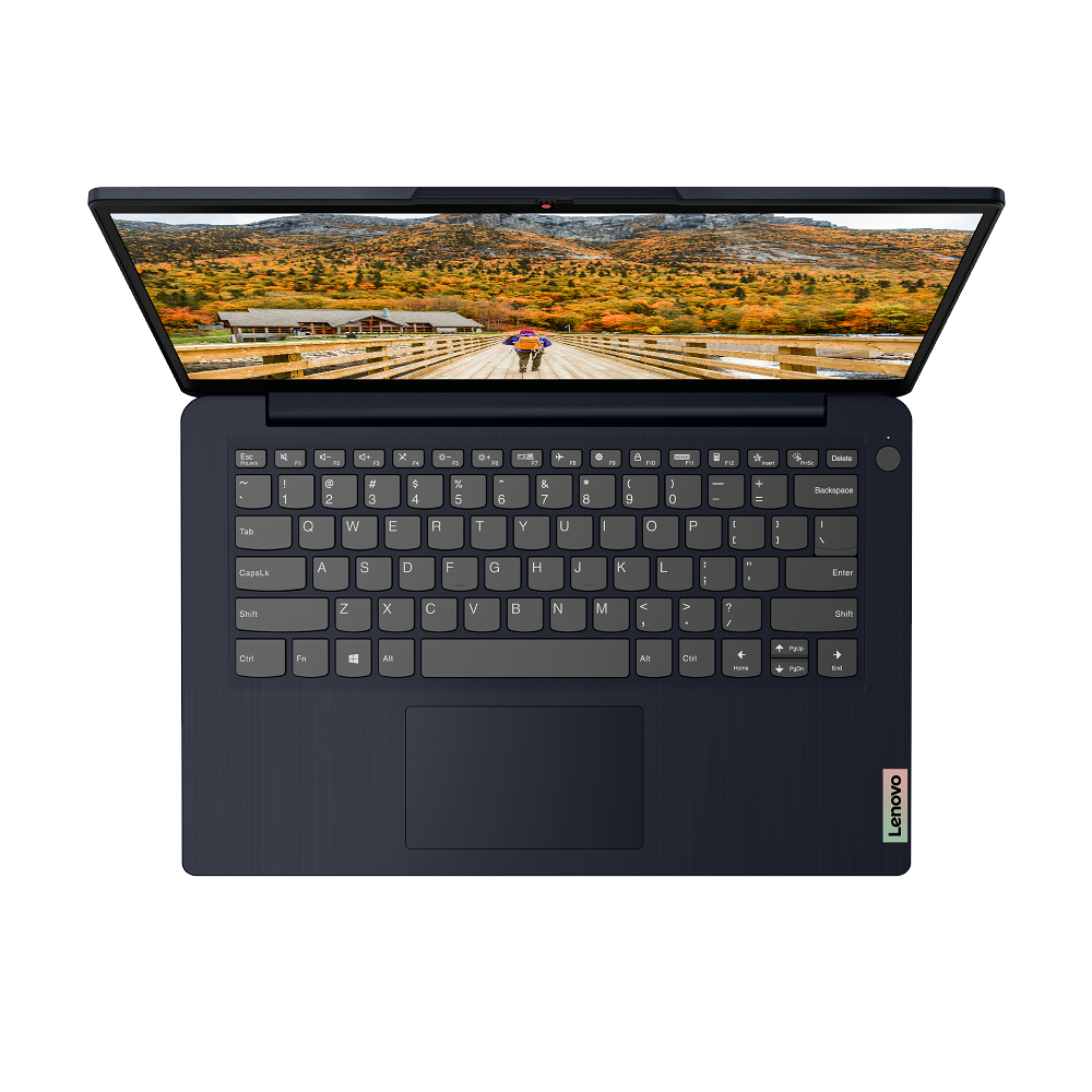 Portátil abierto sobre la mesa. La pantalla muestra una escena de otoño. Teclado y panel táctil.