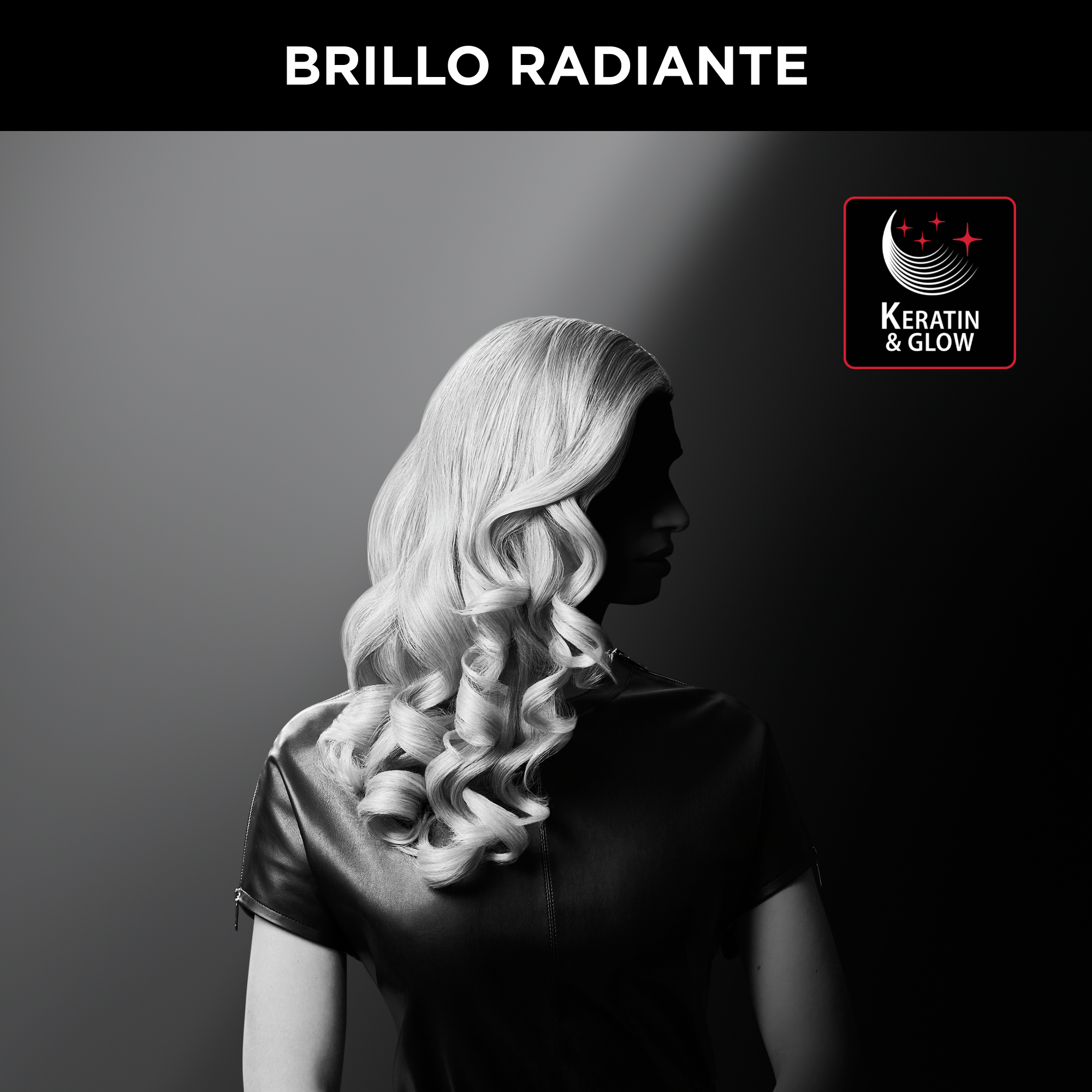 Mujer con cabello rubio y rizado. Lleva un top de cuero negro sobre un fondo oscuro, gris.