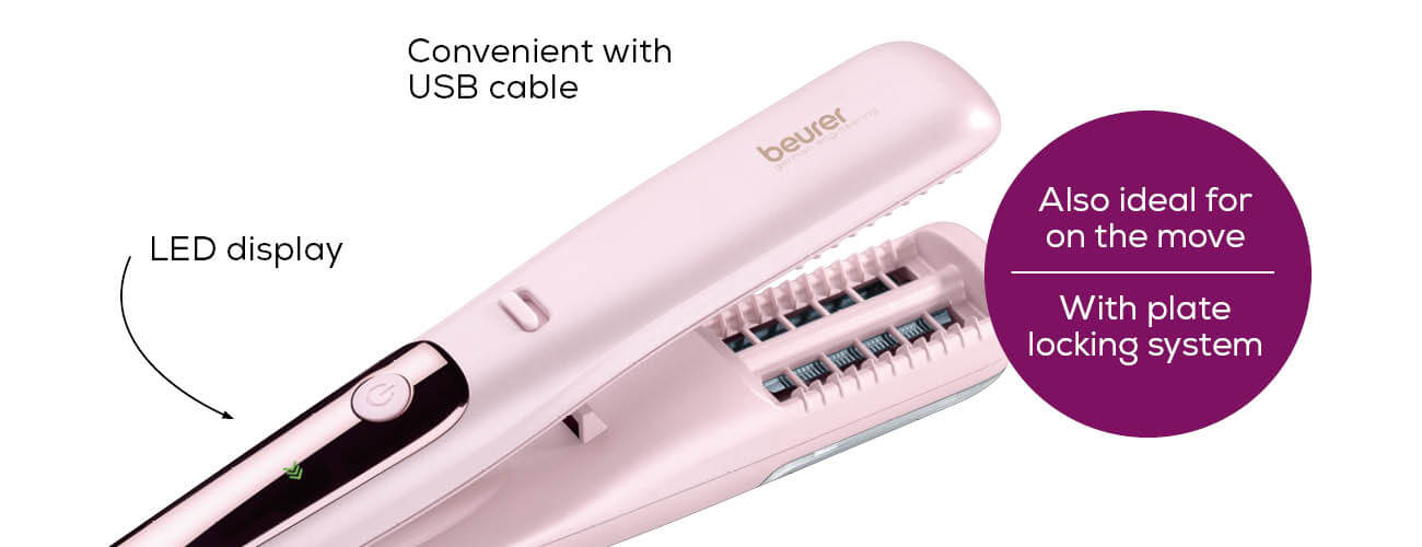 Ein pinkfarbener Haarglätter, geöffnet, mit USB-Kabel und LED-Anzeige, beschriftet 'beurer'.