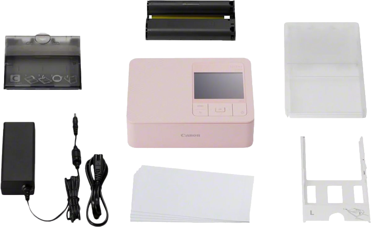 Ein rosa Canon Selphy Fotodrucker mit Zubehör.