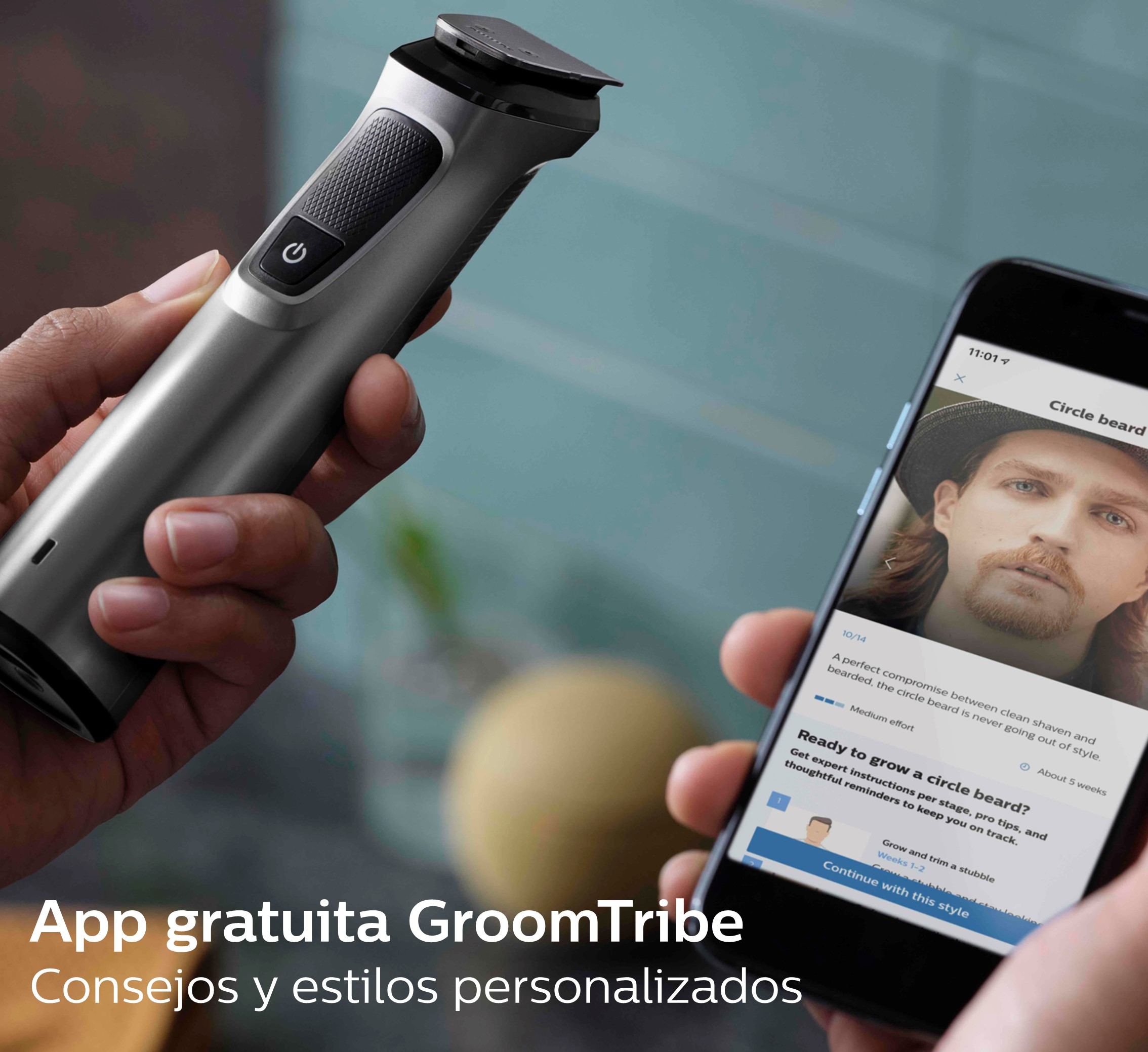 Un hombre sosteniendo una recortadora negra y plateada con un teléfono que muestra consejos de estilo de barba.